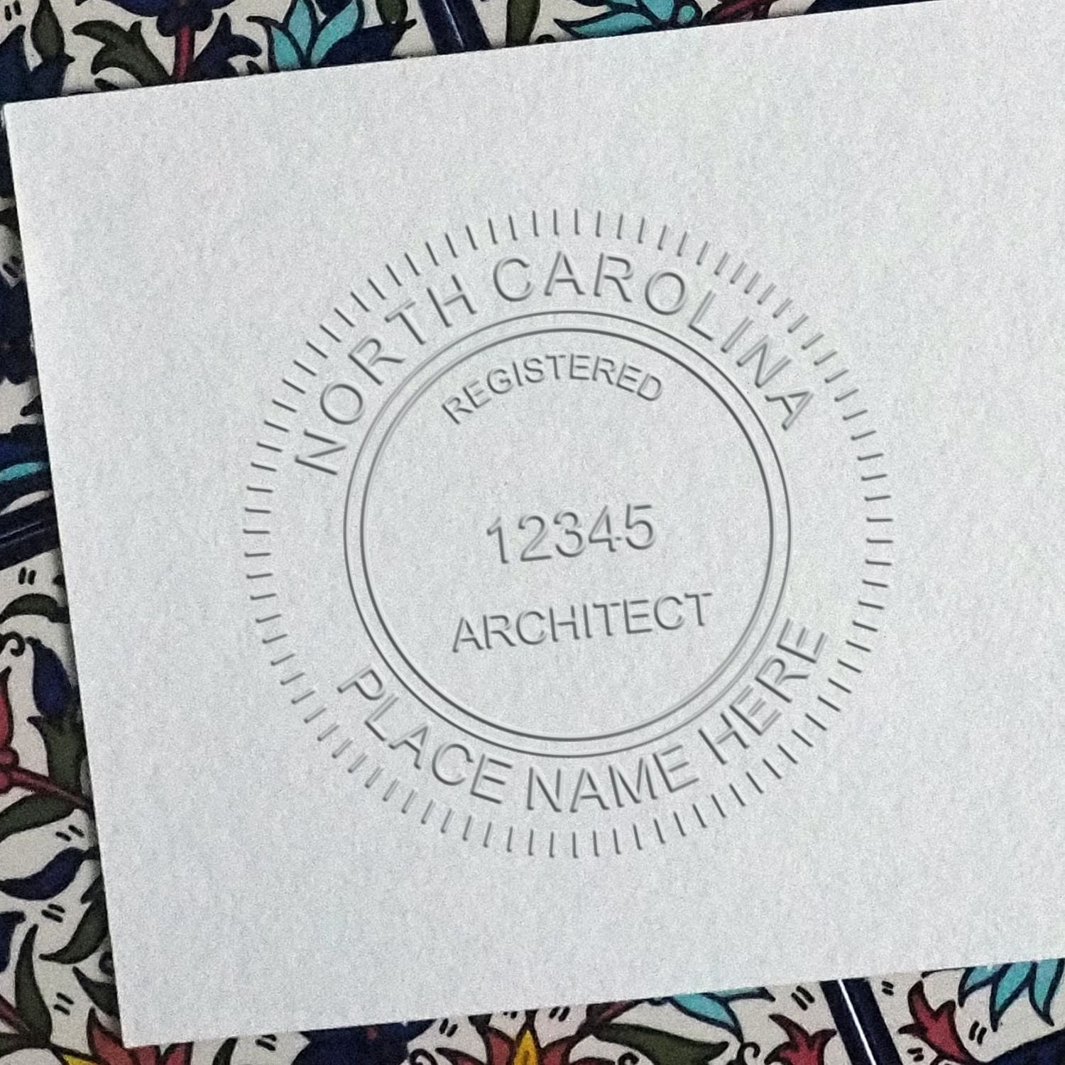 A stamped impression of the North Carolina Desk Architect Embossing Seal in this stylish lifestyle photo, setting the tone for a unique and personalized product.