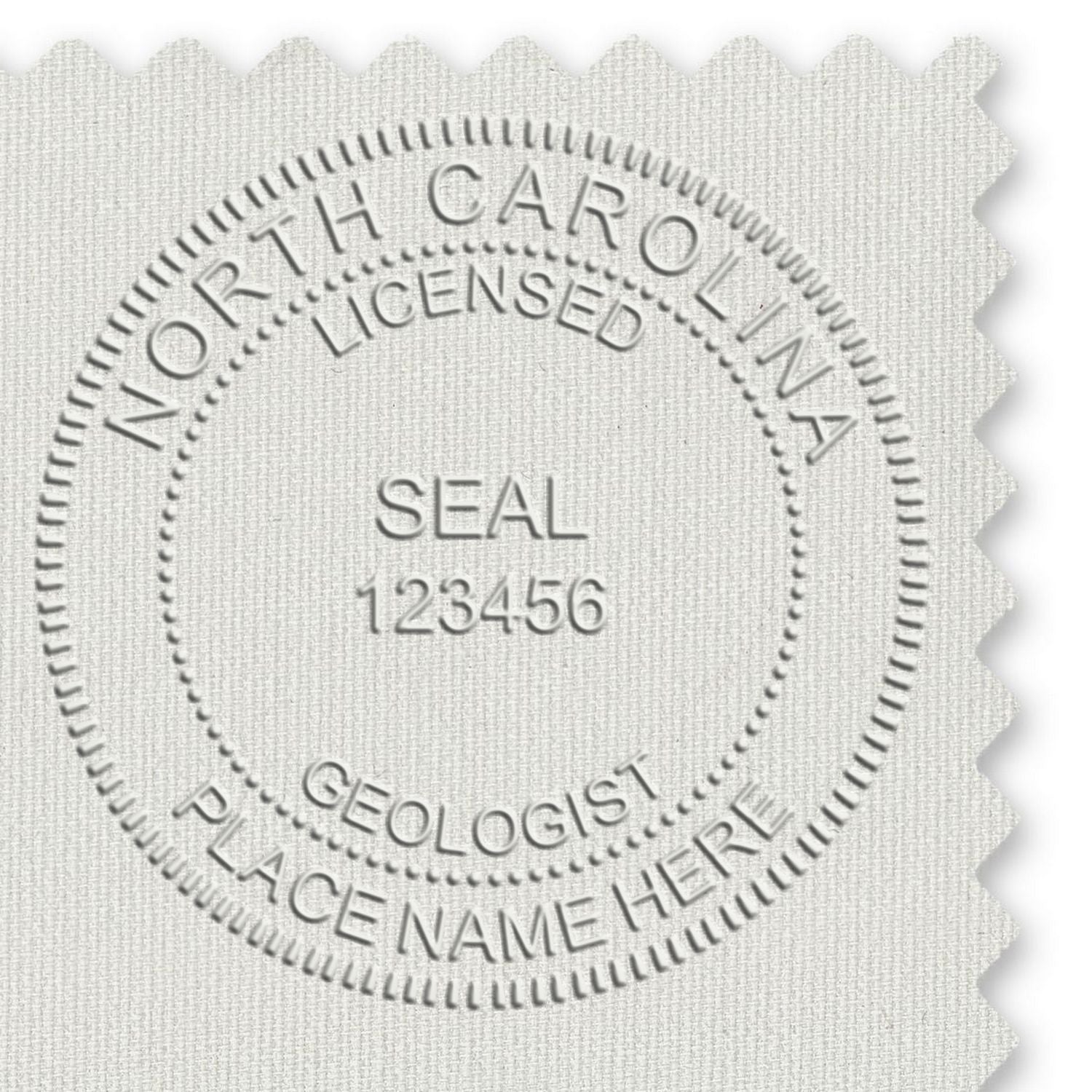 A lifestyle photo showing a stamped image of the Heavy Duty Cast Iron North Carolina Geologist Seal Embosser on a piece of paper