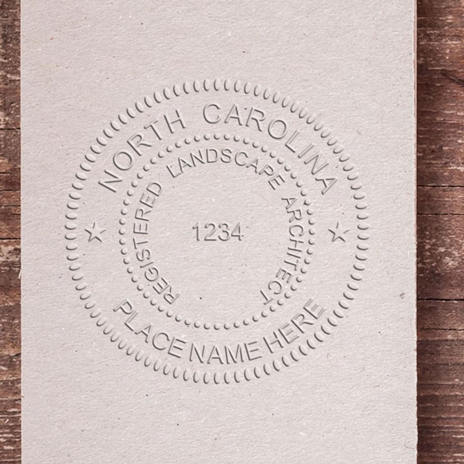 A stamped impression of the State of North Carolina Handheld Landscape Architect Seal in this stylish lifestyle photo, setting the tone for a unique and personalized product.