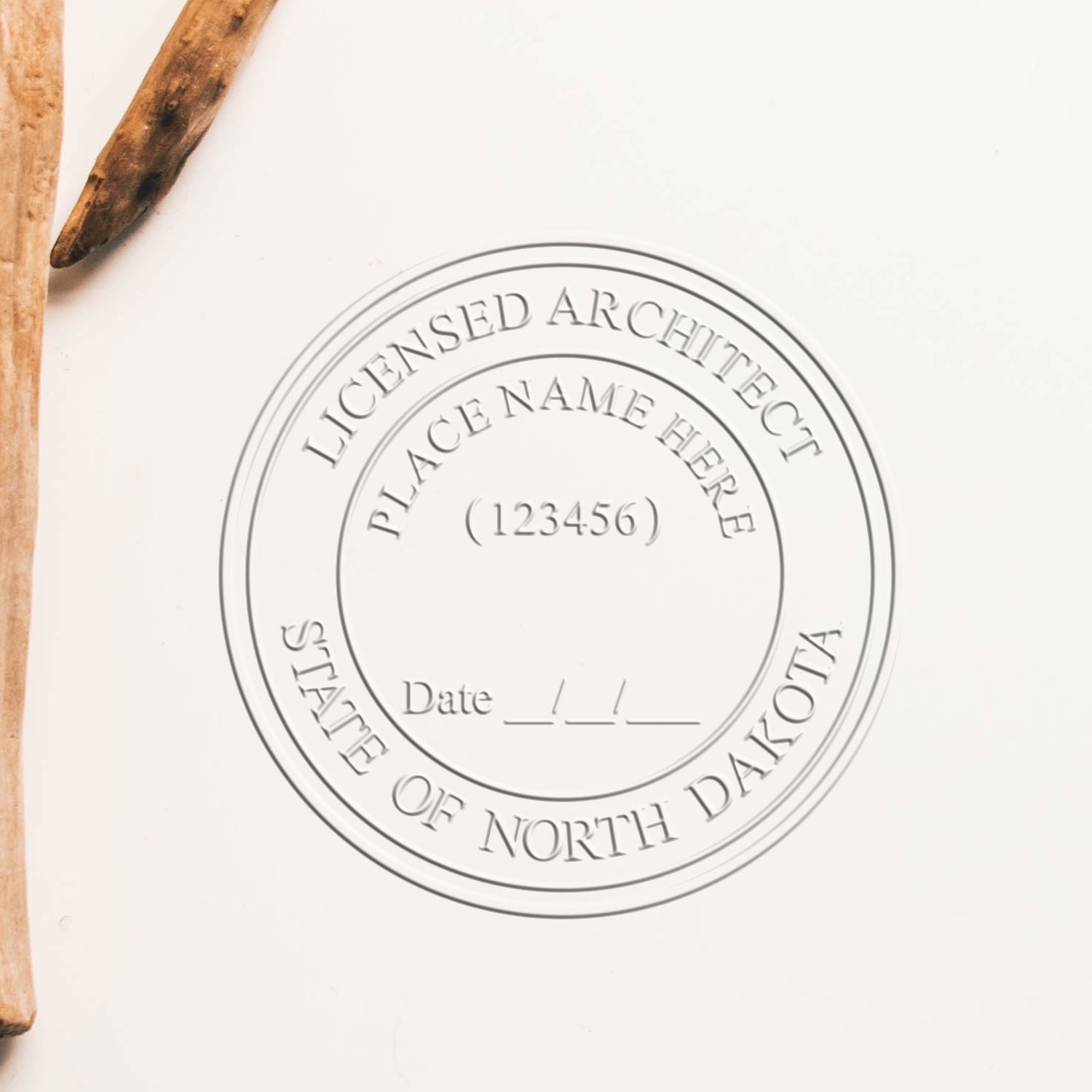 A lifestyle photo showing a stamped image of the North Dakota Desk Architect Embossing Seal on a piece of paper