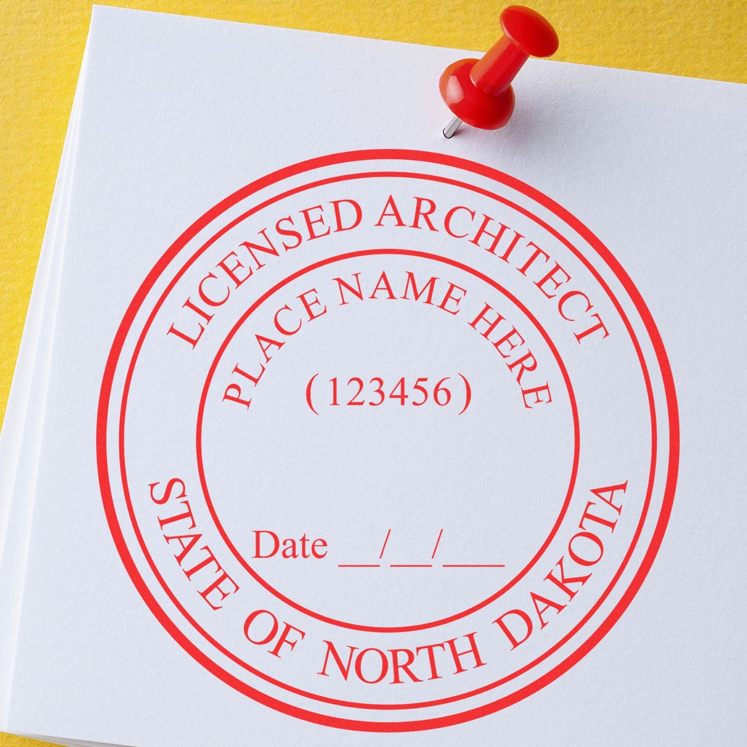 Premium MaxLight Pre-Inked North Dakota Architectural Stamp with customizable fields for name, license number, and date, pinned on a yellow surface.