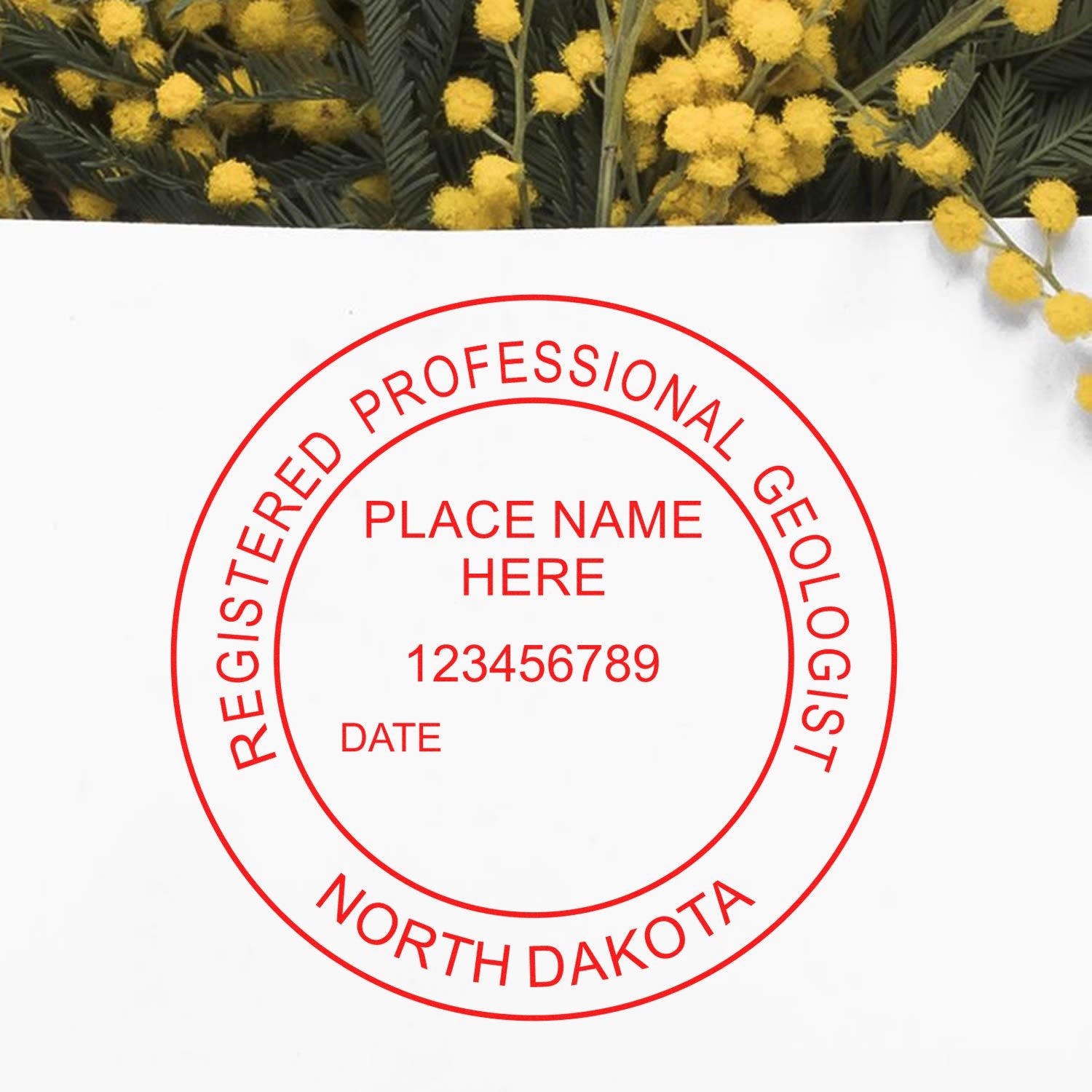 An in use photo of the Slim Pre-Inked North Dakota Professional Geologist Seal Stamp showing a sample imprint on a cardstock