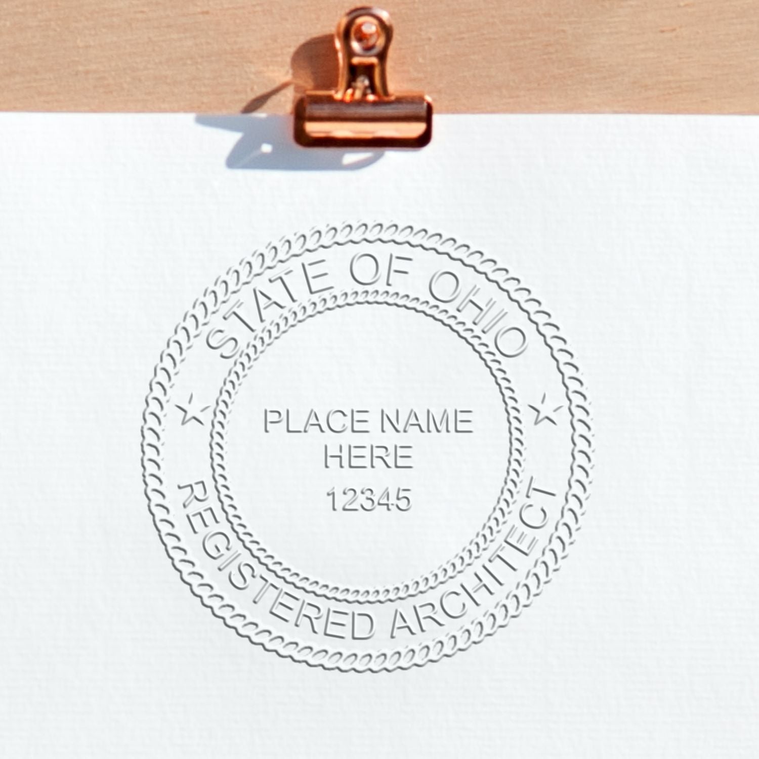 A lifestyle photo showing a stamped image of the Ohio Desk Architect Embossing Seal on a piece of paper