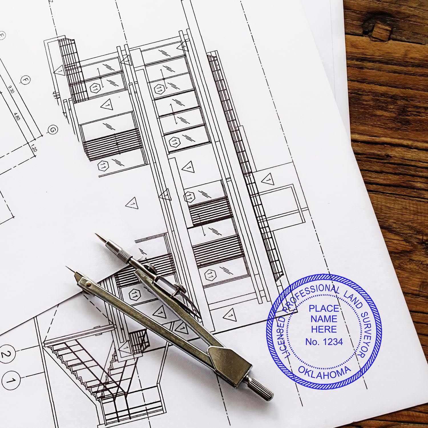 Oklahoma Land Surveyor Seal Stamp on architectural plans with a compass on a wooden table.