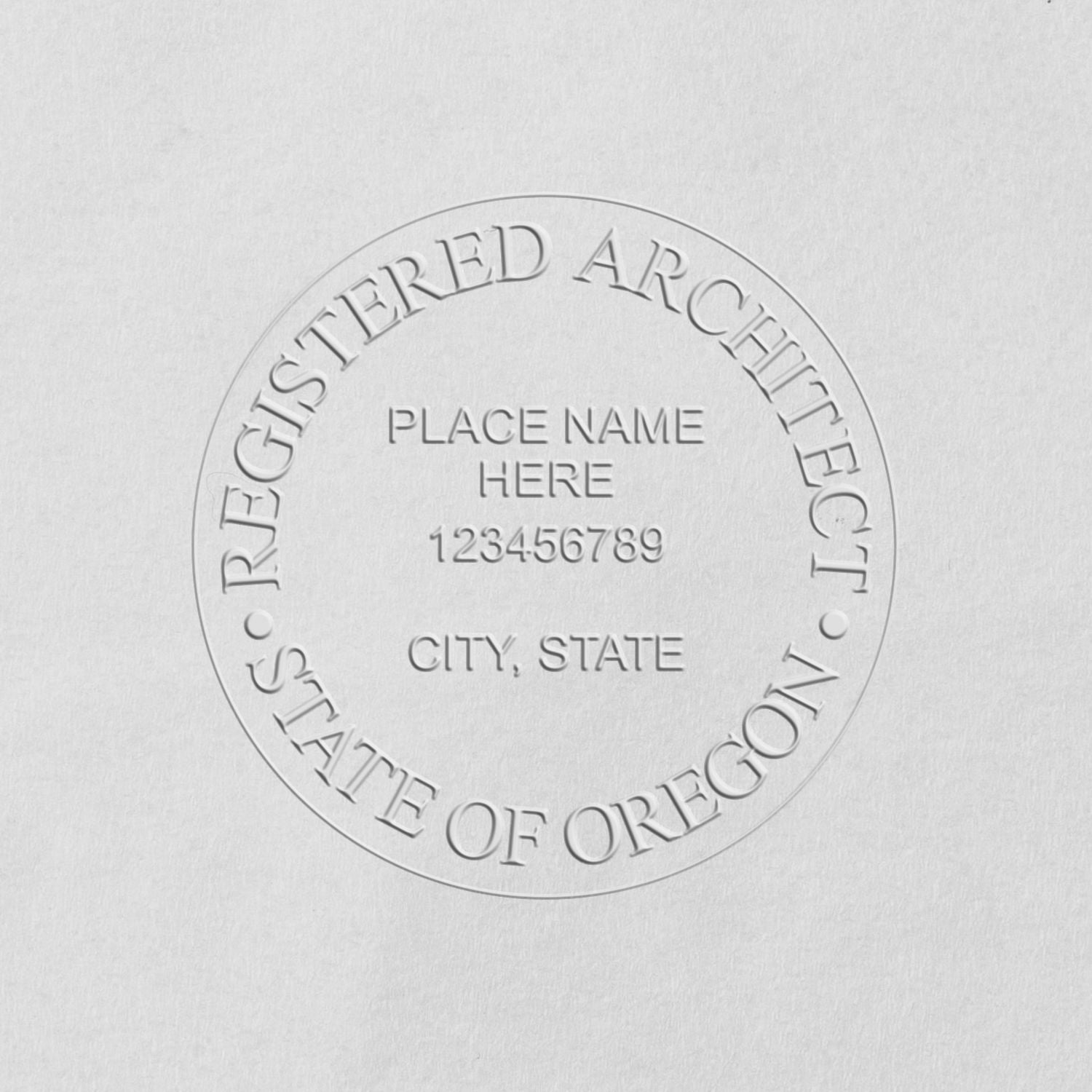 A lifestyle photo showing a stamped image of the Handheld Oregon Architect Seal Embosser on a piece of paper