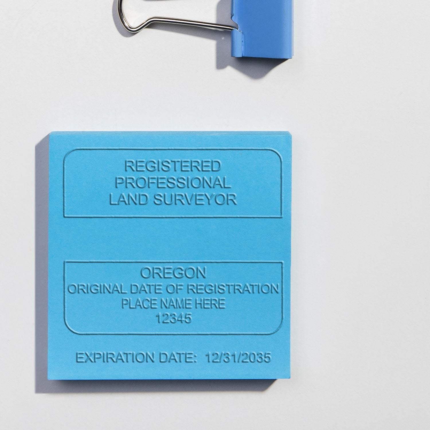 Another Example of a stamped impression of the State of Oregon Soft Land Surveyor Embossing Seal on a piece of office paper.