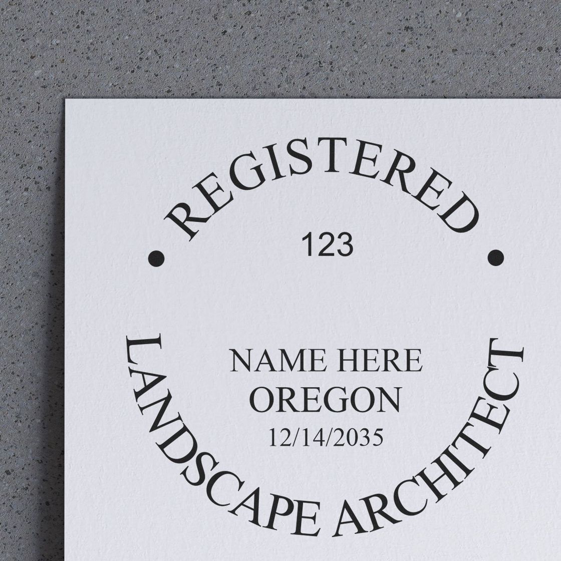 A lifestyle photo showing a stamped image of the Digital Oregon Landscape Architect Stamp on a piece of paper