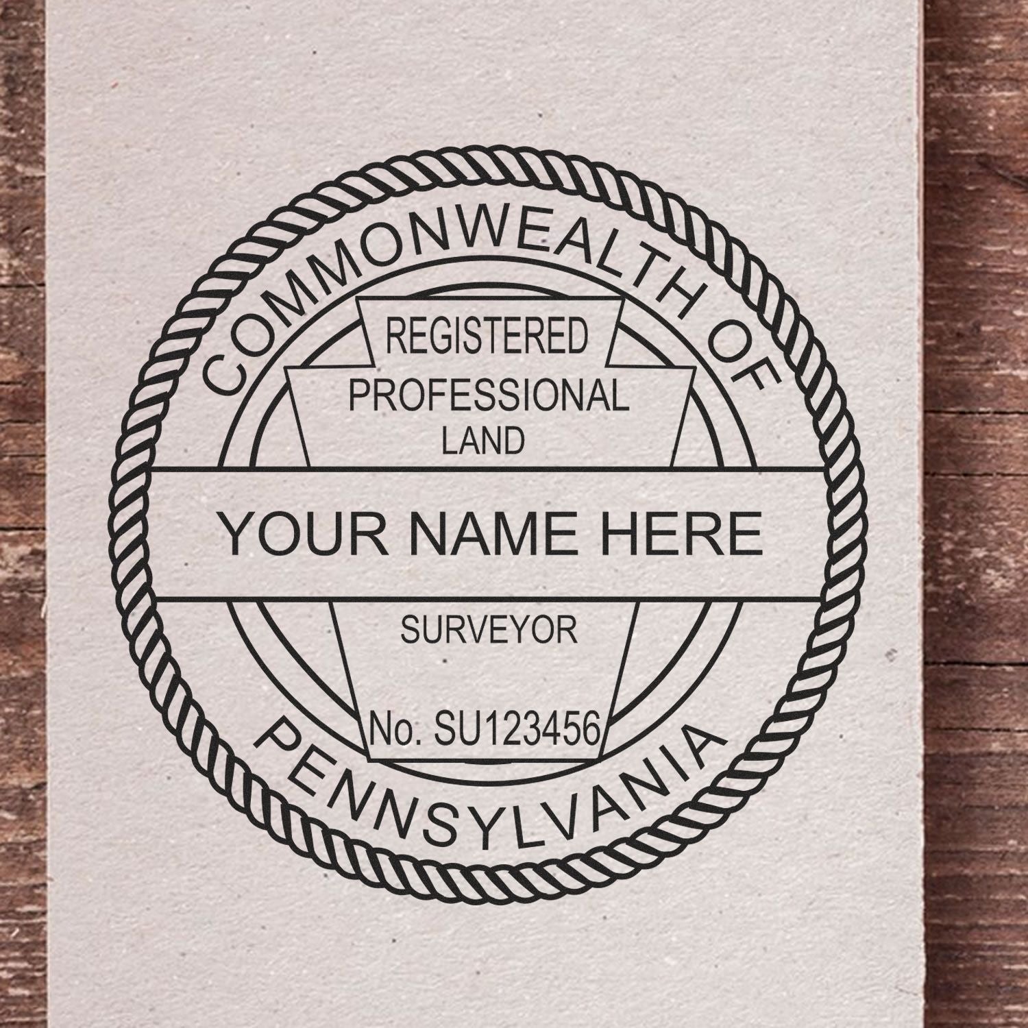 Self Inking Pennsylvania Land Surveyor Stamp on paper, displaying customizable text for name and registration number.