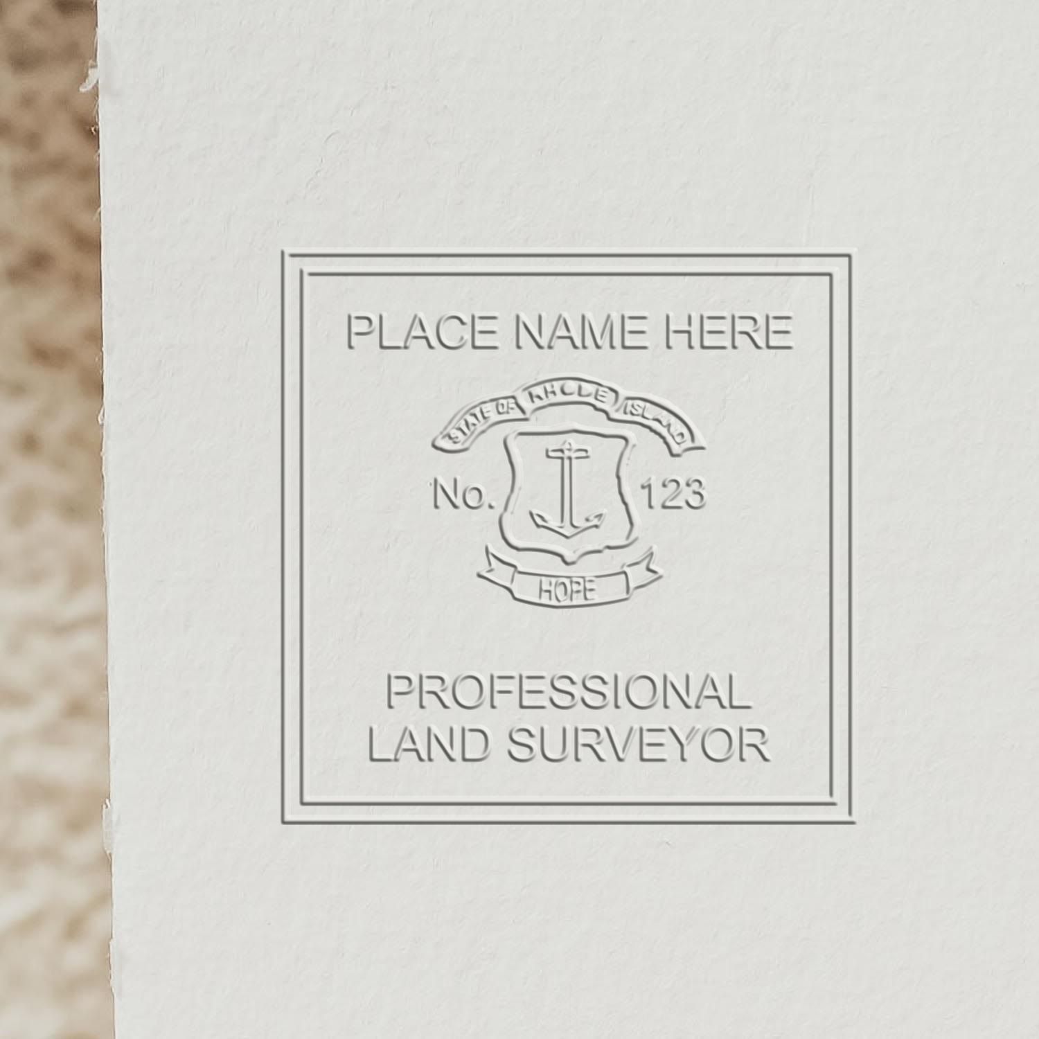 A lifestyle photo showing a stamped image of the Rhode Island Desk Surveyor Seal Embosser on a piece of paper