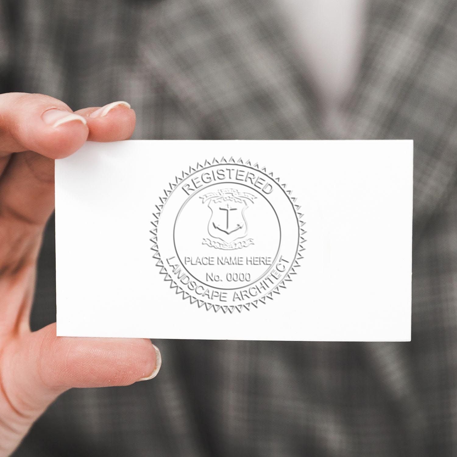 An in use photo of the Gift Rhode Island Landscape Architect Seal showing a sample imprint on a cardstock