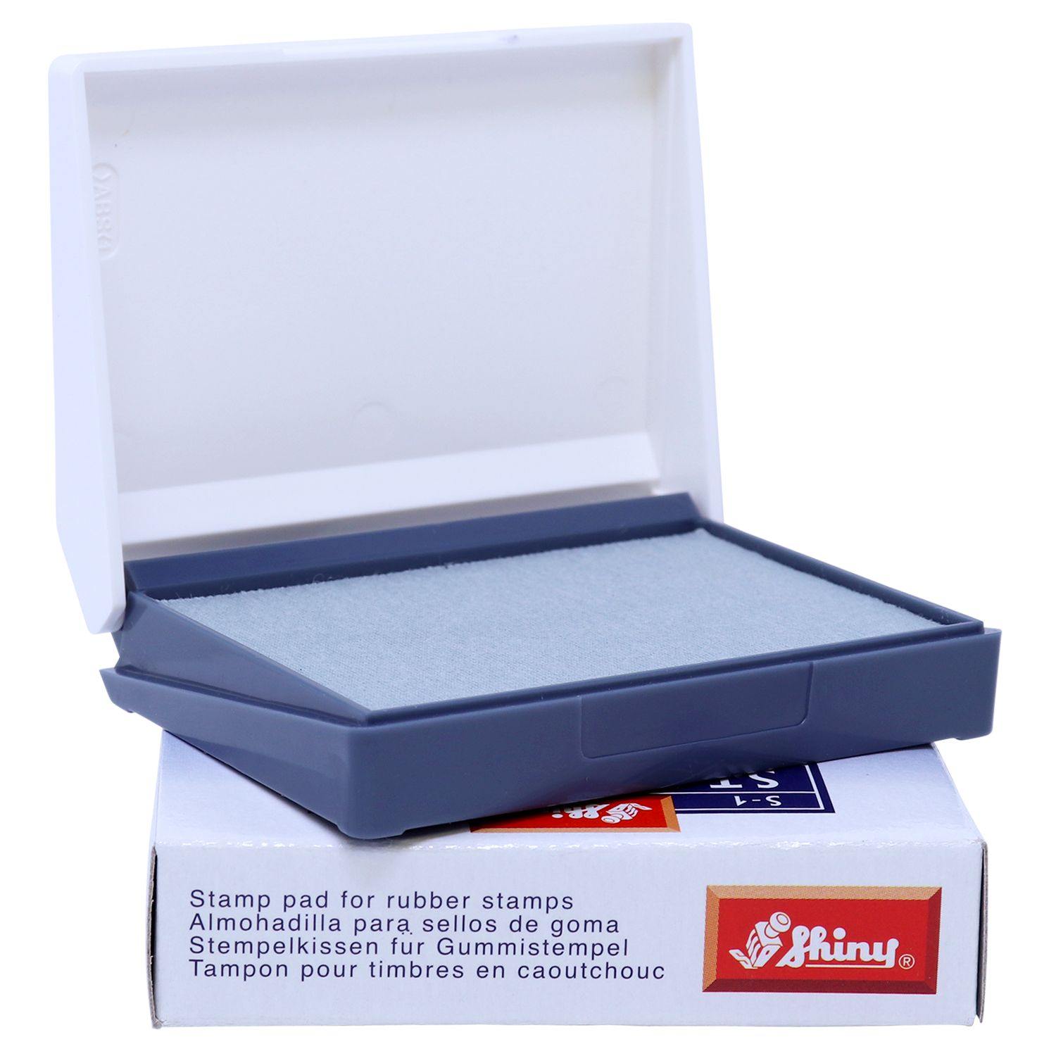 Rubber Stamp Ink Pad 00 Size 1-1/2 x 2-3/4 in a gray plastic case with a white lid, placed on a branded box with multilingual text.