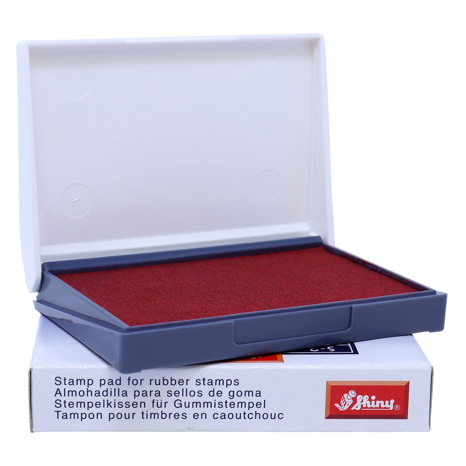 Rubber Stamp Ink Pad 0 Size 2-1/4 x 3-1/2 in red, open with a white lid, placed on its packaging box.