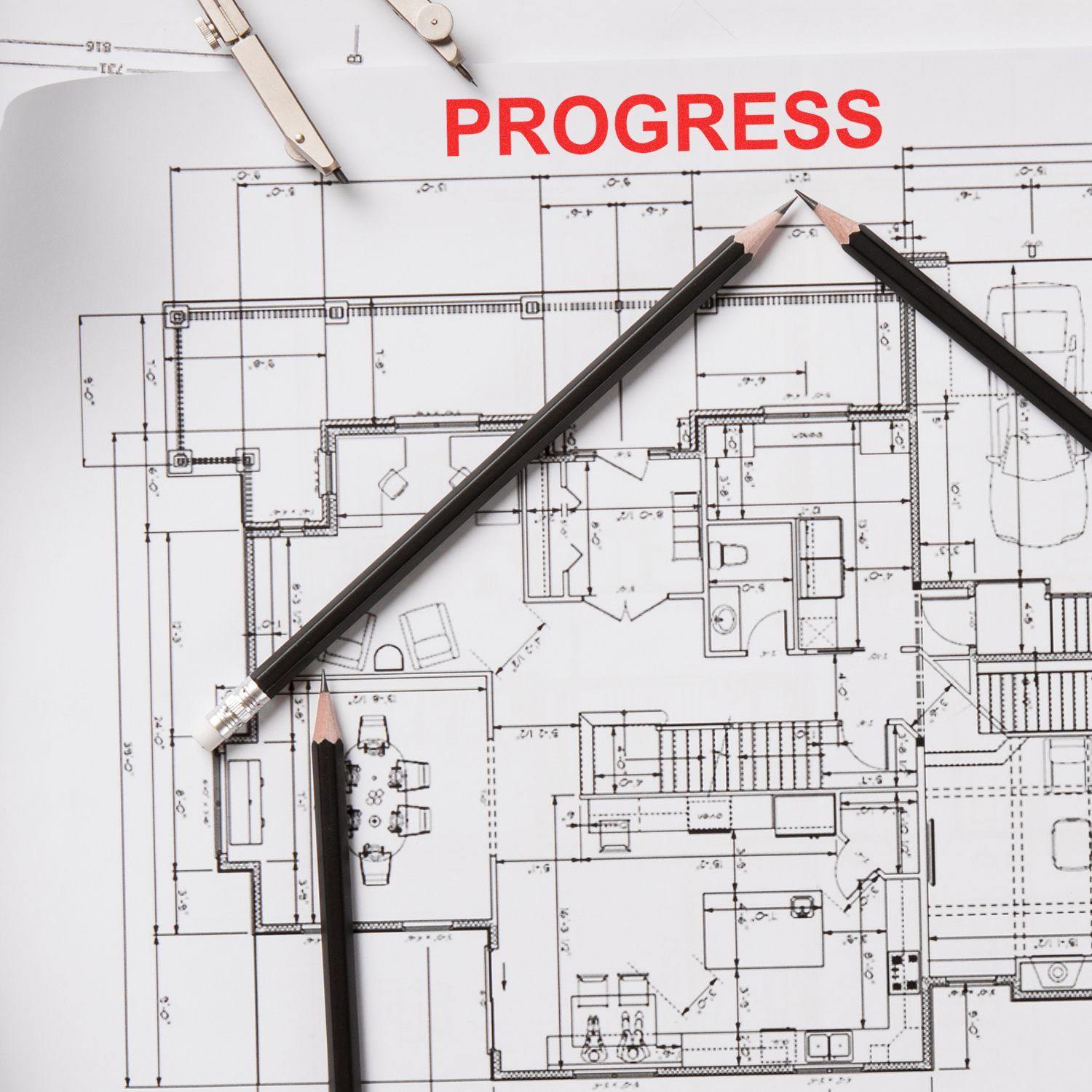 Self Inking Progress Stamp marking PROGRESS in red on architectural blueprints with three black pencils arranged on the plans.