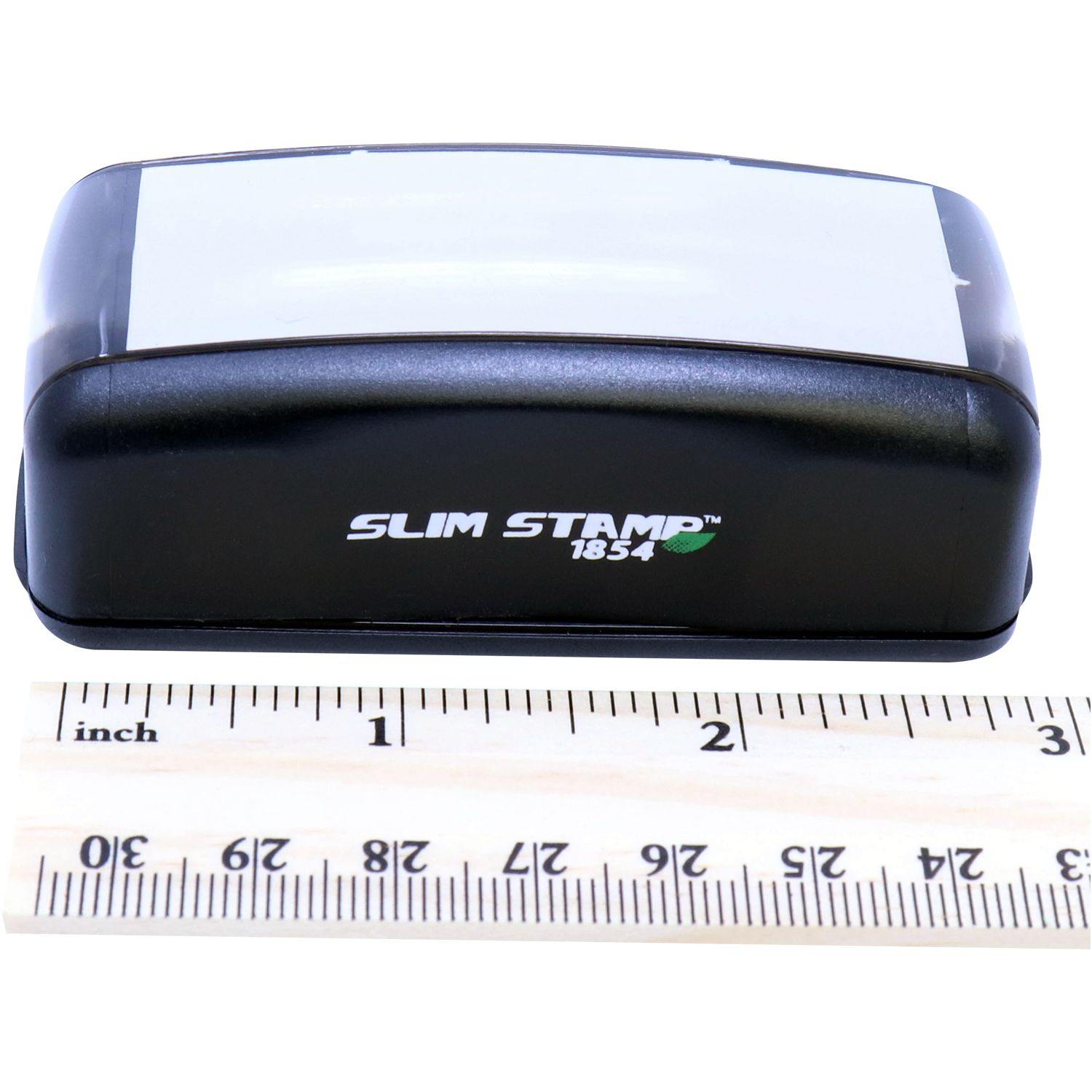 Slim Pre-Inked Progress Stamp in black with a transparent cover, placed next to a ruler for size reference.