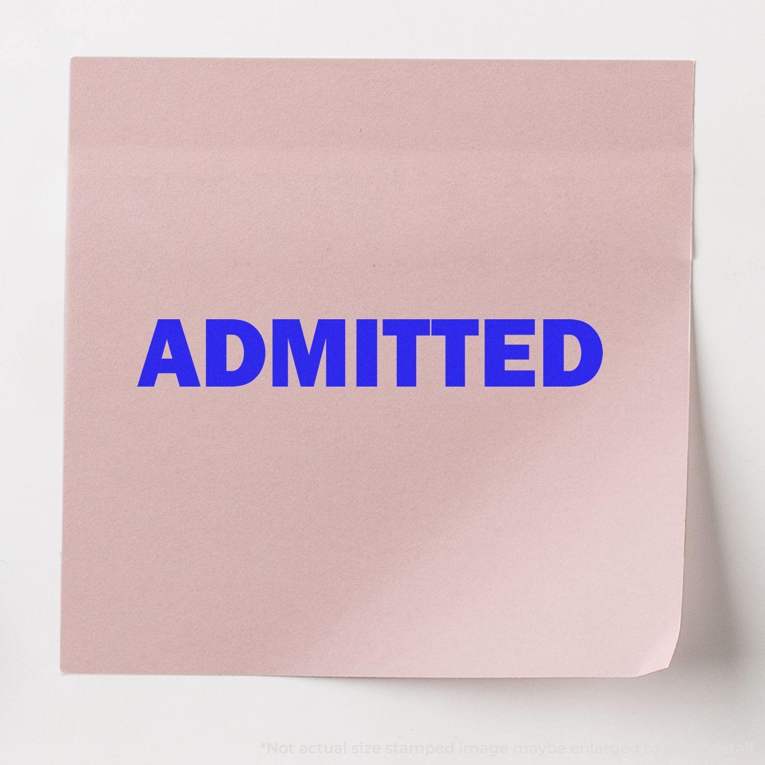 Pink paper with the word ADMITTED stamped in bold blue ink using the Self Inking Admitted Stamp.