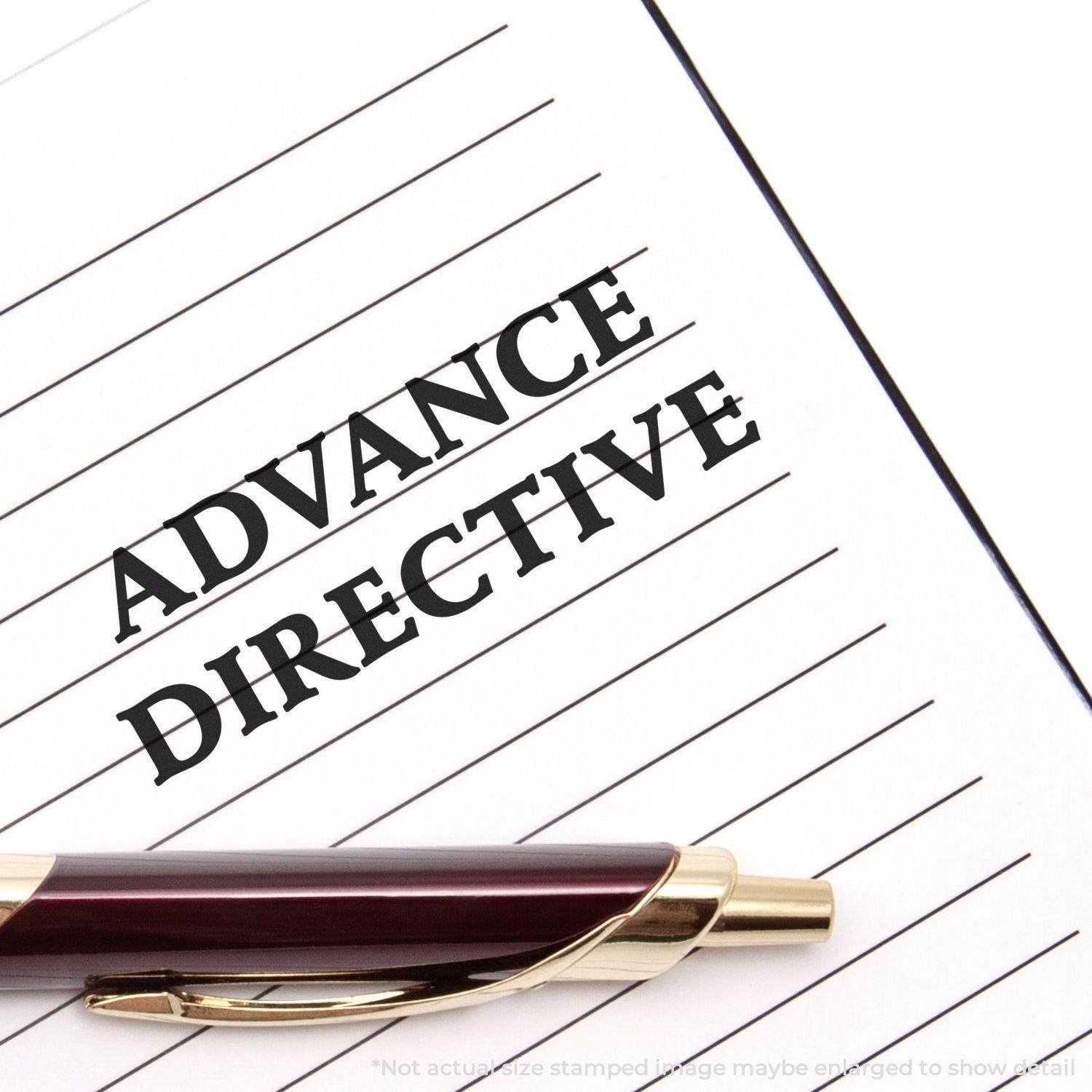 A Self Inking Advance Directive Stamp marks ADVANCE DIRECTIVE on a lined paper, with a pen placed diagonally across the page.