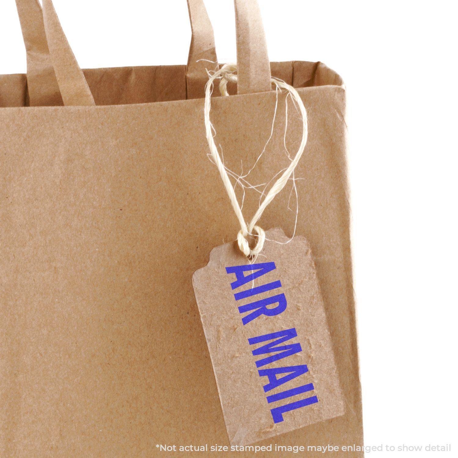 Brown paper bag with a tag stamped AIR MAIL using the Large Air Mail Rubber Stamp, attached with twine.