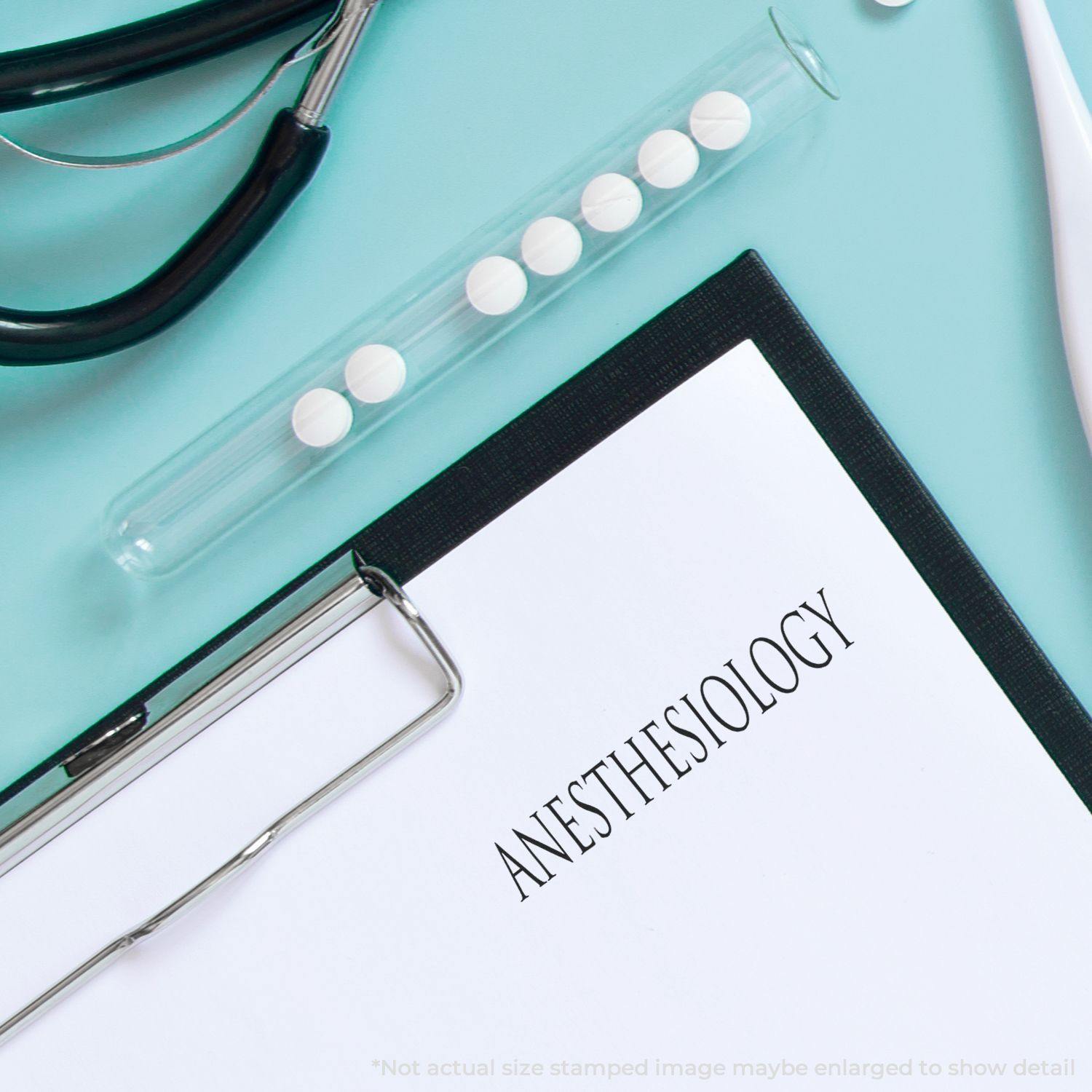 Clipboard with ANESTHESIOLOGY stamped on paper using Self Inking Amortizado Stamp, alongside stethoscope and test tube with pills.