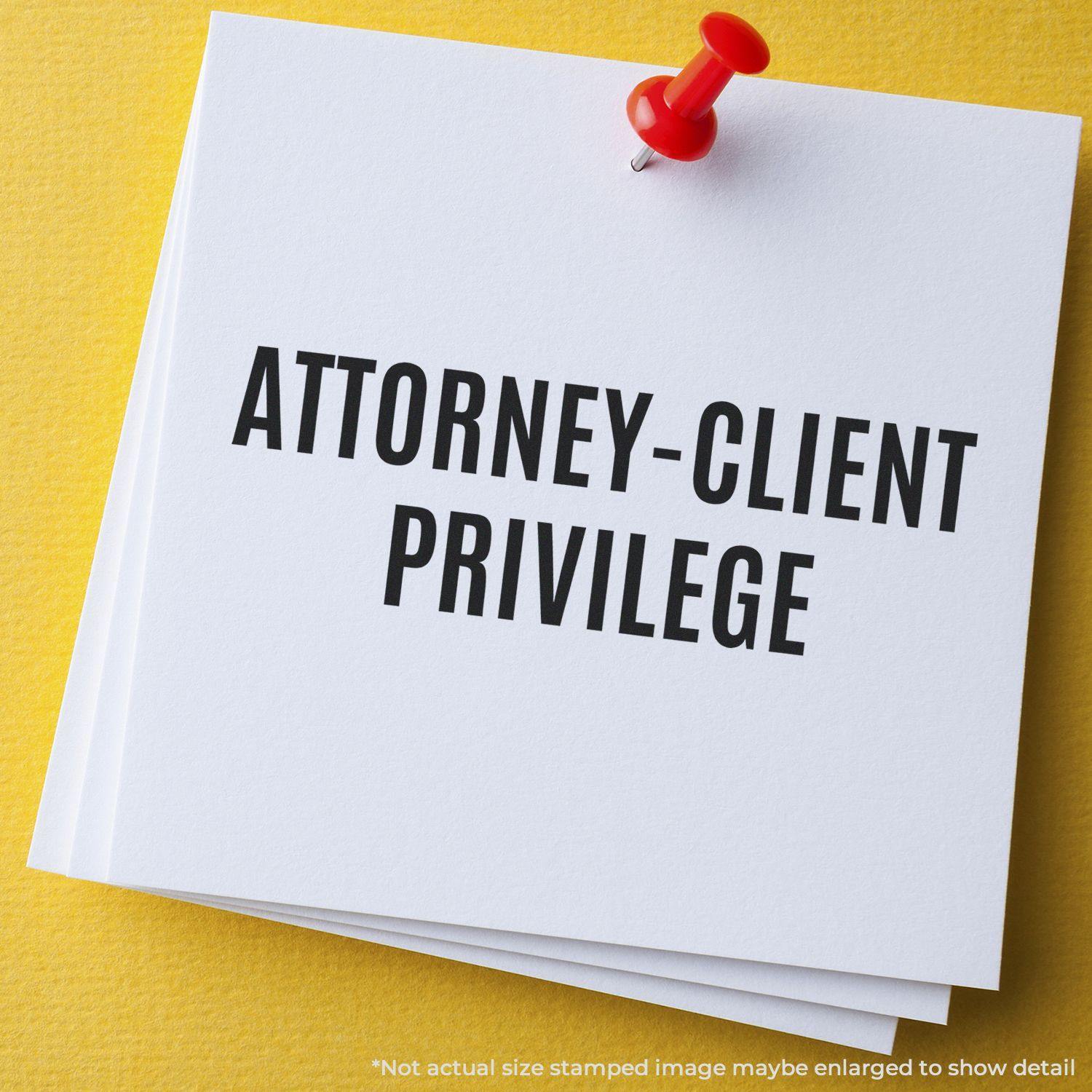 Self Inking Attorney-Client Privilege Stamp used on white paper, pinned with a red pushpin on a yellow surface.