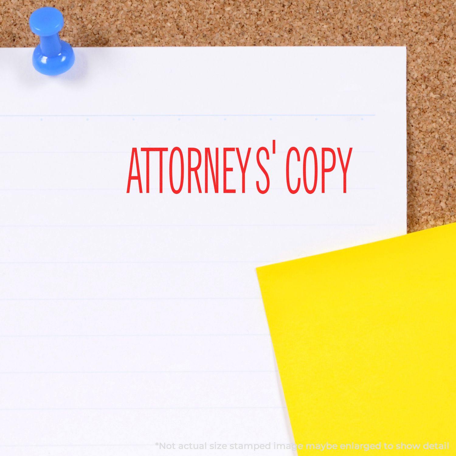 Self Inking Attorneys' Copy Stamp in red ink on white paper pinned to a corkboard, with a yellow sticky note beside it.