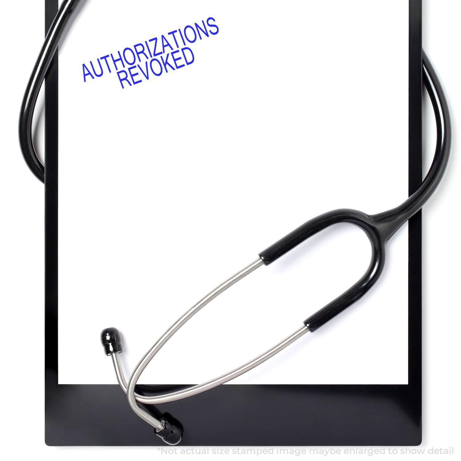 A clipboard with a stethoscope and a paper stamped Authorizations Revoked in blue ink.