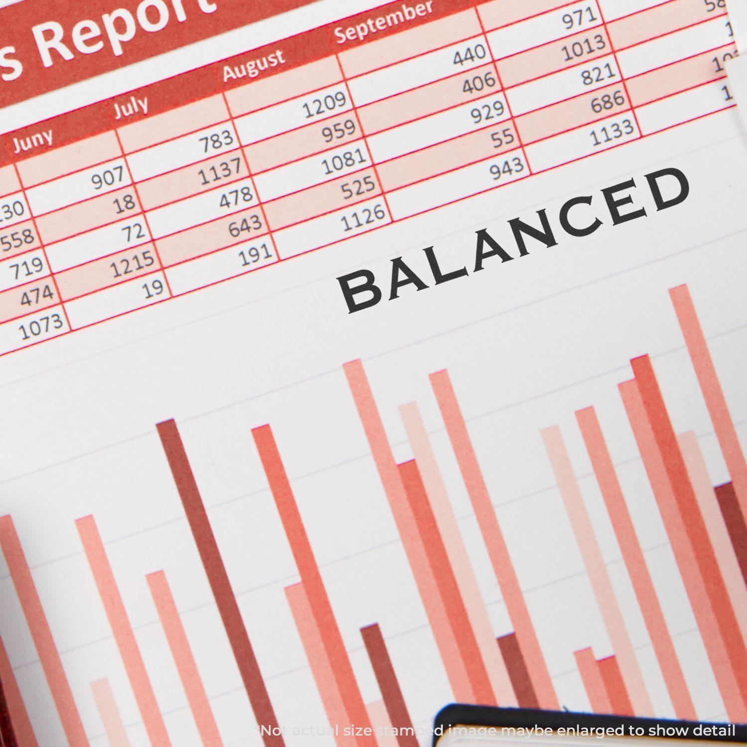 A Large Balanced Rubber Stamp marks BALANCED on a financial report with red bar graphs and a table of monthly data.