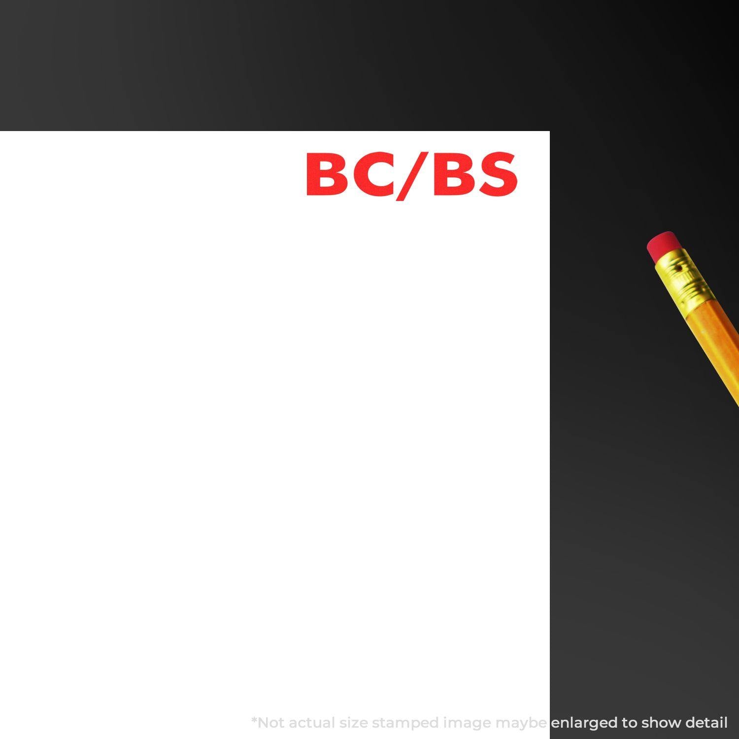 BC/BS Medical Provider Rubber Stamp in red ink on white paper, with a pencil nearby on a dark background.