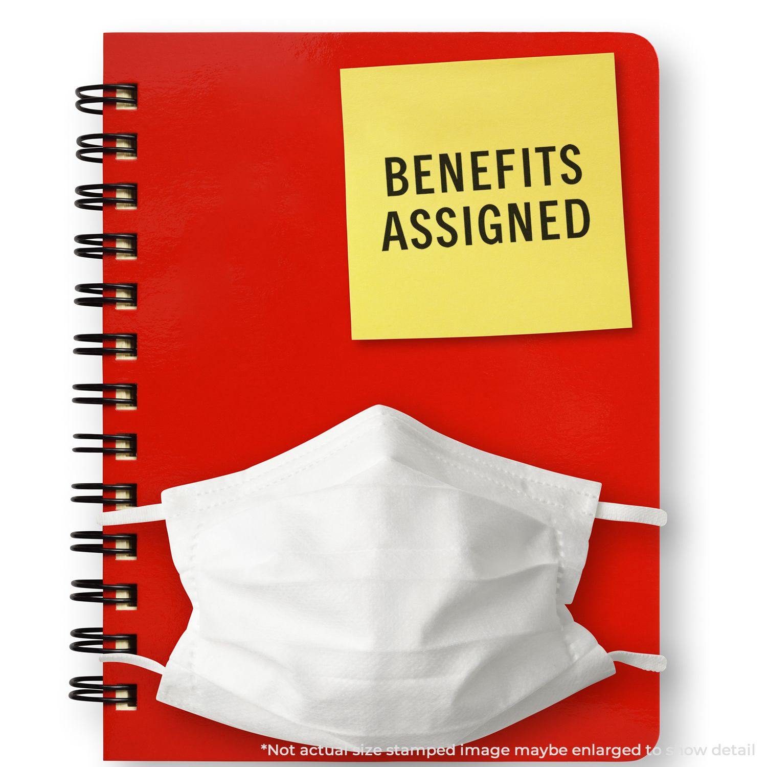 Red notebook with a white mask and a yellow sticky note stamped BENEFITS ASSIGNED using the Large Benefits Assigned Rubber Stamp.