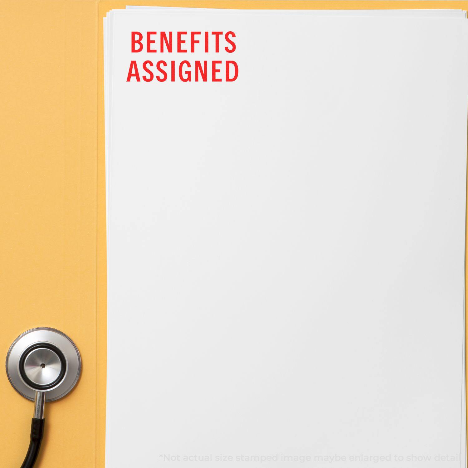 A stack of papers stamped with BENEFITS ASSIGNED in red ink using the Large Benefits Assigned Rubber Stamp, next to a stethoscope.