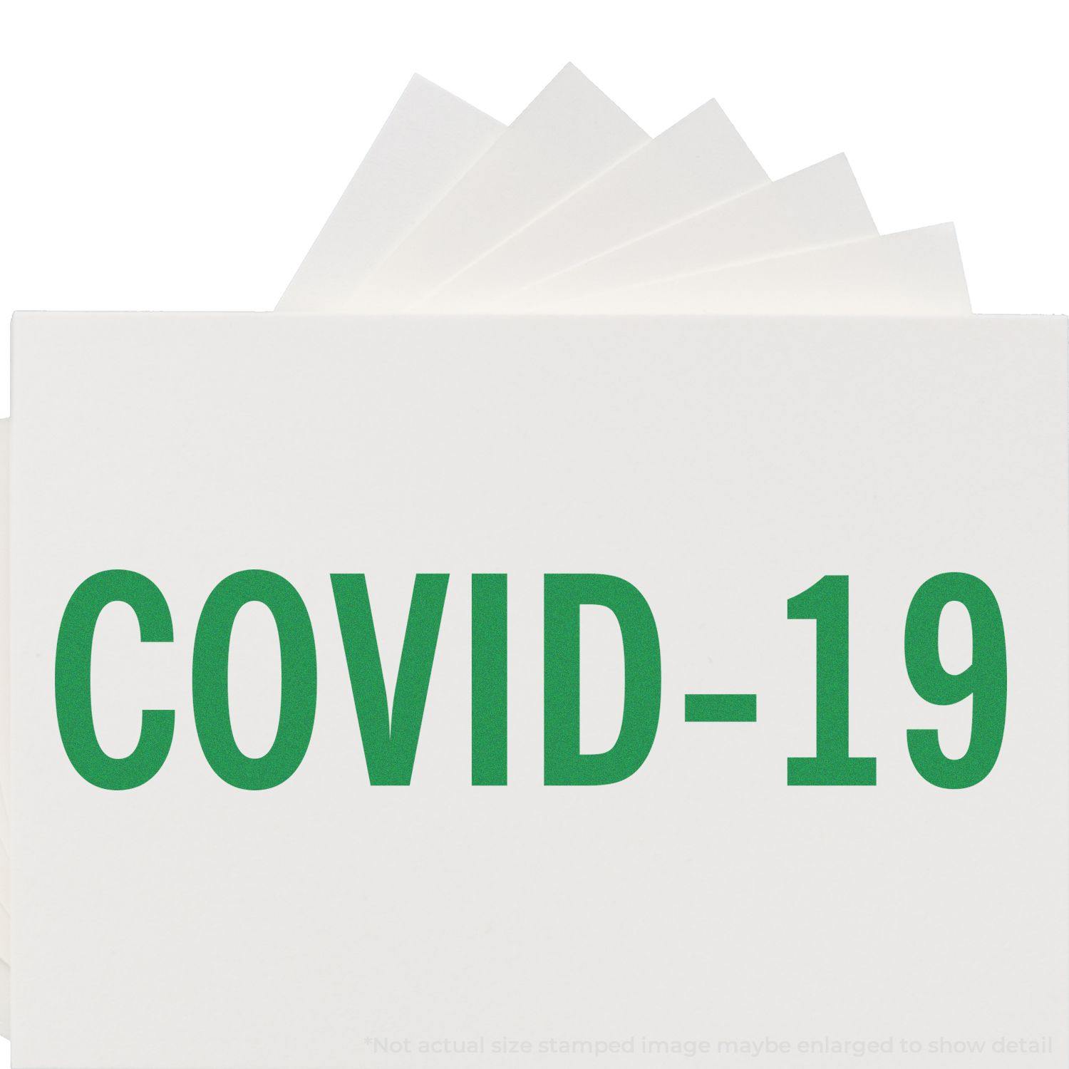 Bold Covid-19 Rubber Stamp in green ink on white paper, with multiple stamped sheets fanned out behind the main stamped sheet.