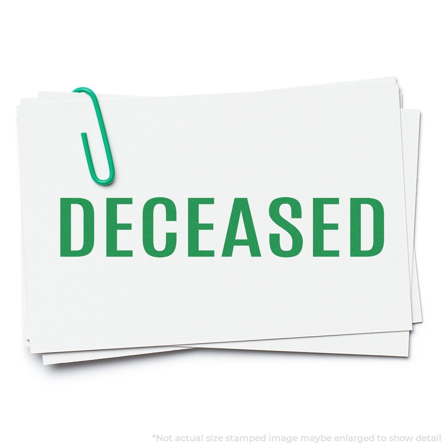 Bold Deceased Rubber Stamp in green ink on white paper, held together with a green paperclip.