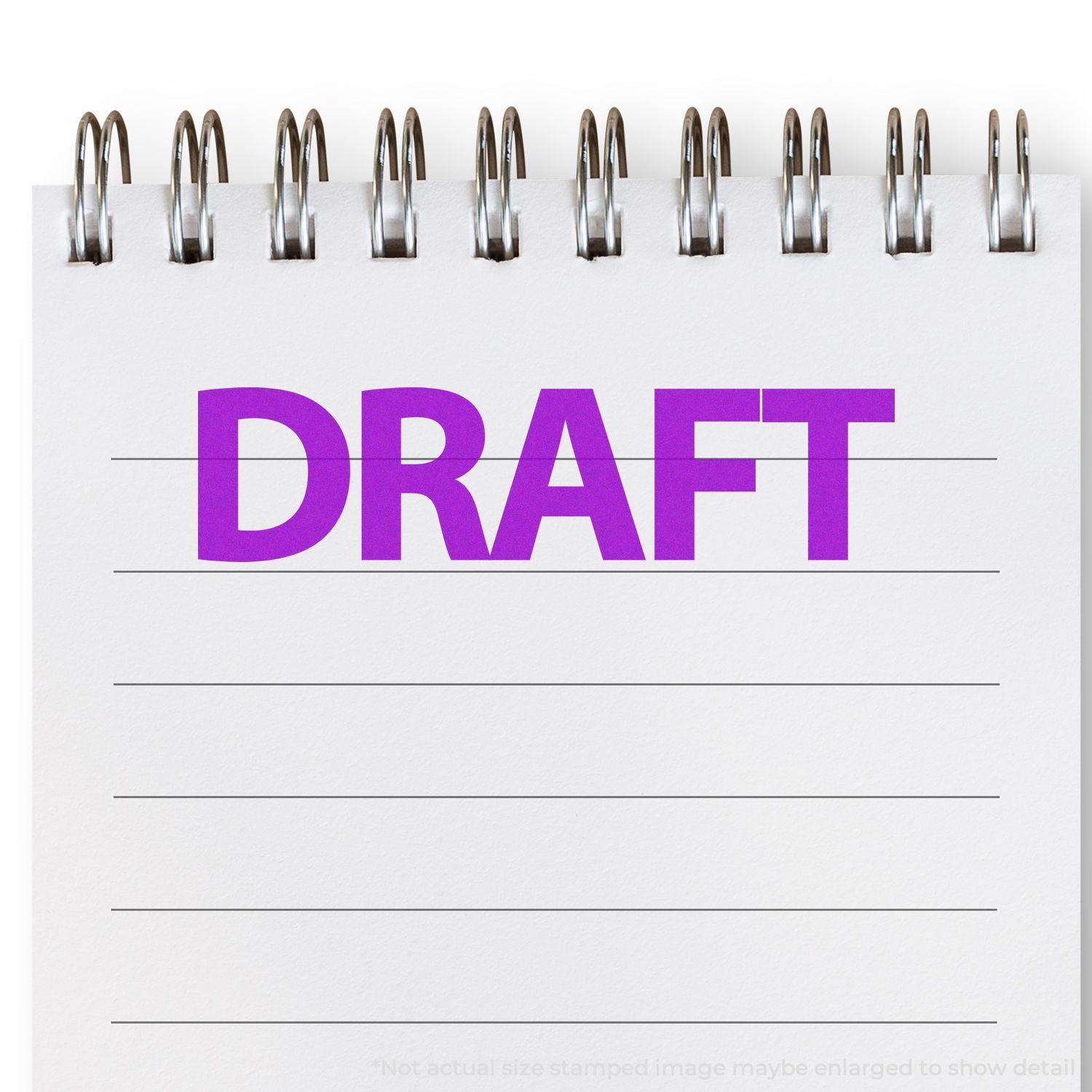 A spiral notebook with lined paper shows a bold, purple DRAFT rubber stamp impression in the center.