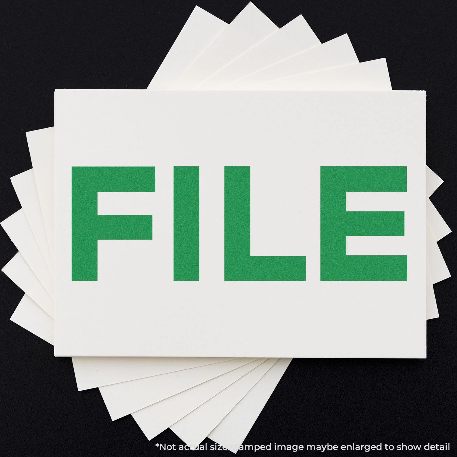 Bold File Rubber Stamp in use, displaying the word FILE in green on a white card, with additional cards underneath.