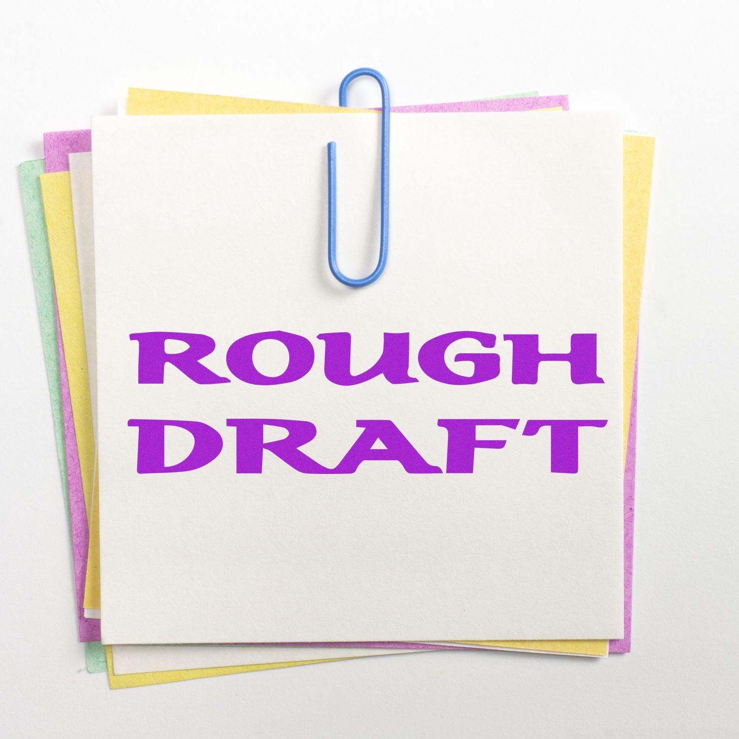 A stack of colorful papers clipped together, stamped with ROUGH DRAFT in bold purple using the Large Self Inking Bold Rough Draft Stamp.