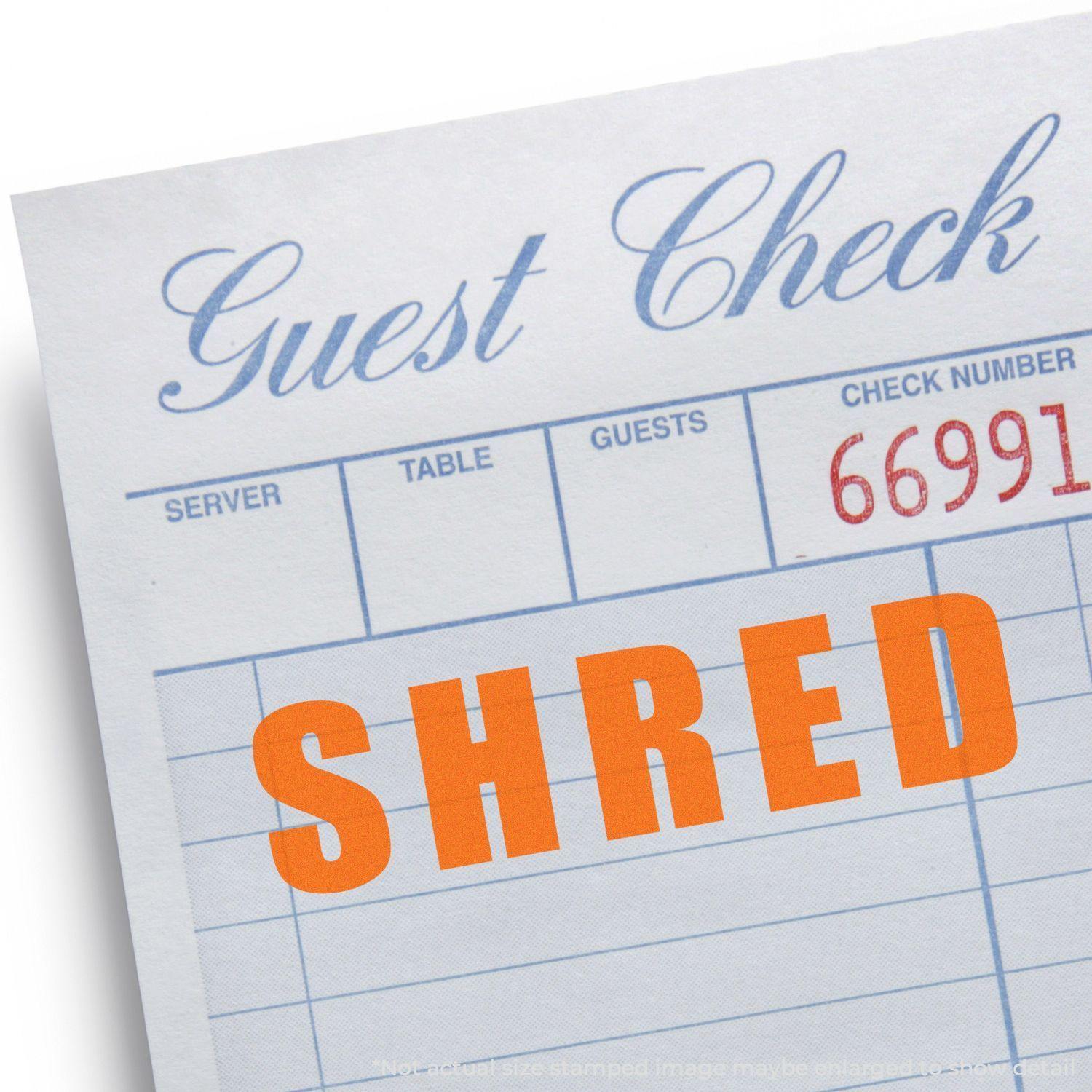 Guest check with SHRED stamped in bold orange letters using the Bold Shred Rubber Stamp.