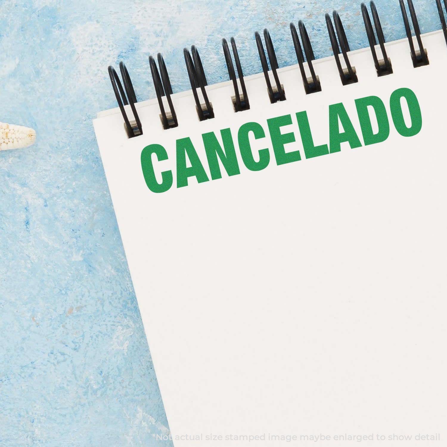 Large Pre-Inked Cancelado Stamp marking CANCELADO in green on a white notepad with a blue background.