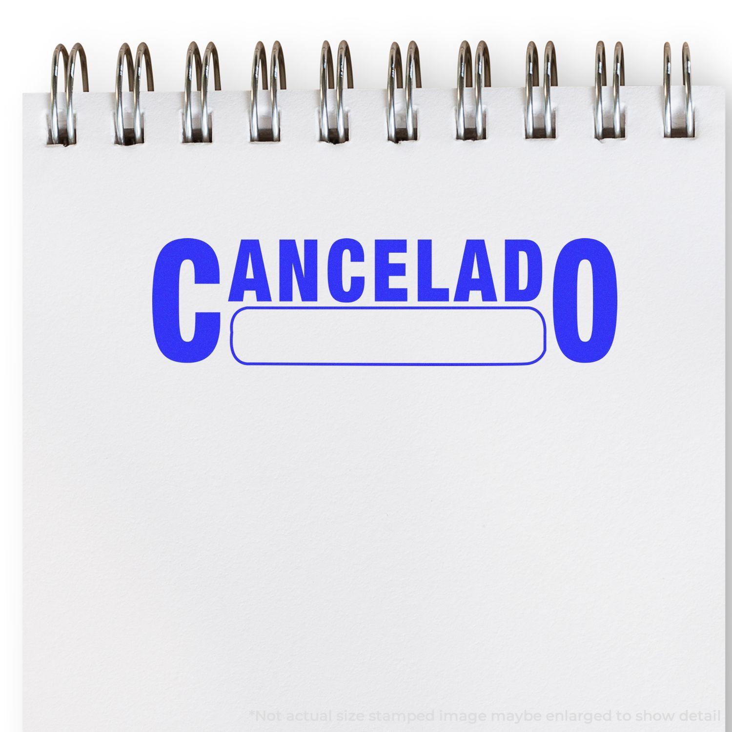 Large Pre-Inked Cancelado with Box Stamp in blue ink on a white notepad with spiral binding.