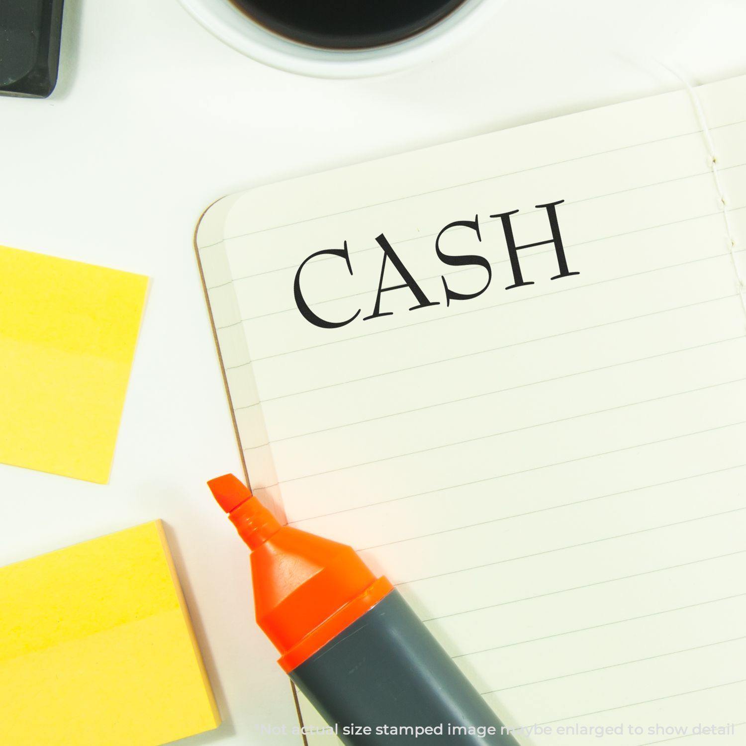 Self Inking Cash Stamp used on a notebook page with the word CASH stamped, surrounded by a highlighter and sticky notes.