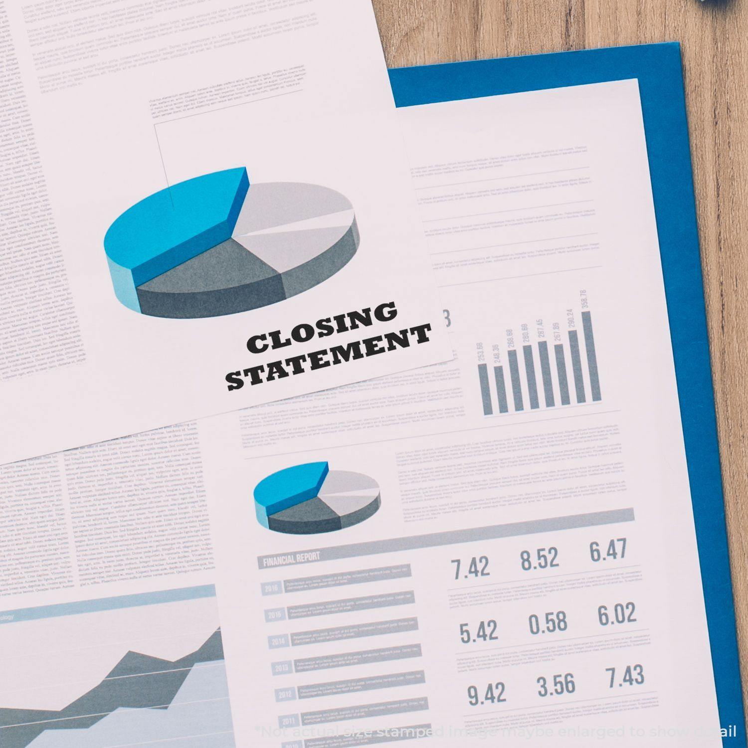 Large Pre-Inked Closing Statement Stamp used on a financial report with charts and graphs on a desk.