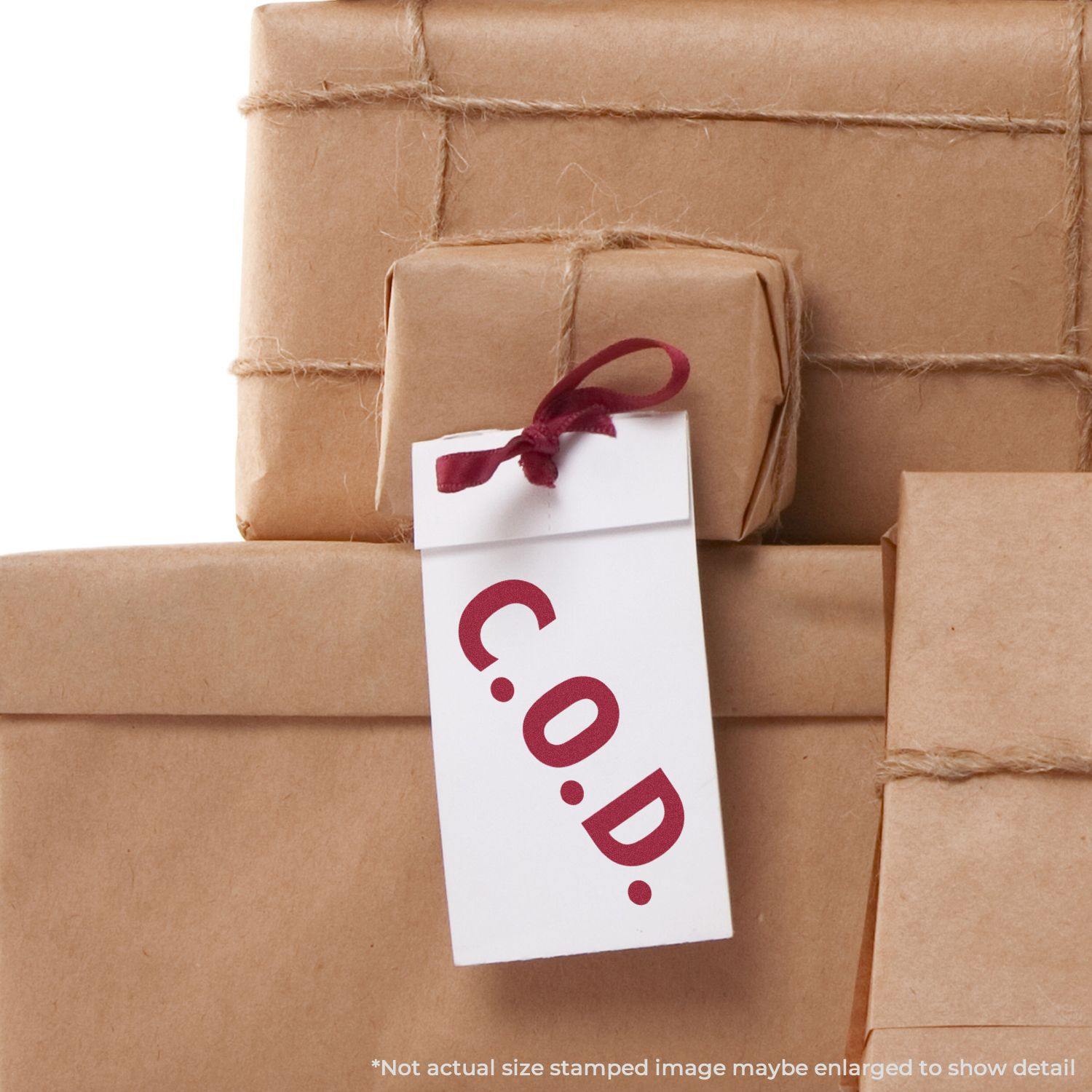 A stack of brown paper-wrapped packages with a tag stamped C.O.D. using a Self Inking COD Stamp.