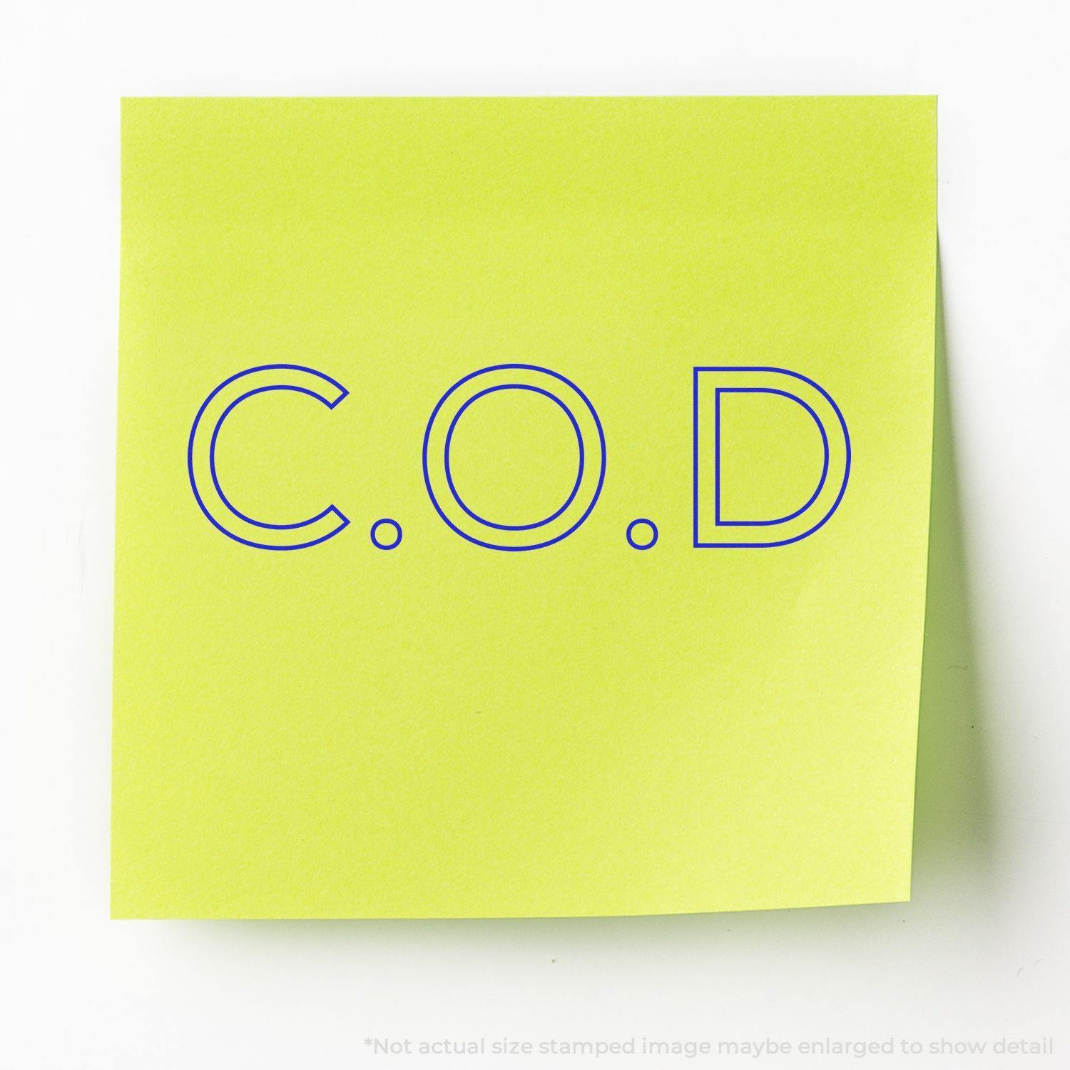 Large Pre-Inked COD Outline Stamp on a yellow sticky note, displaying the text C.O.D in blue outline letters.