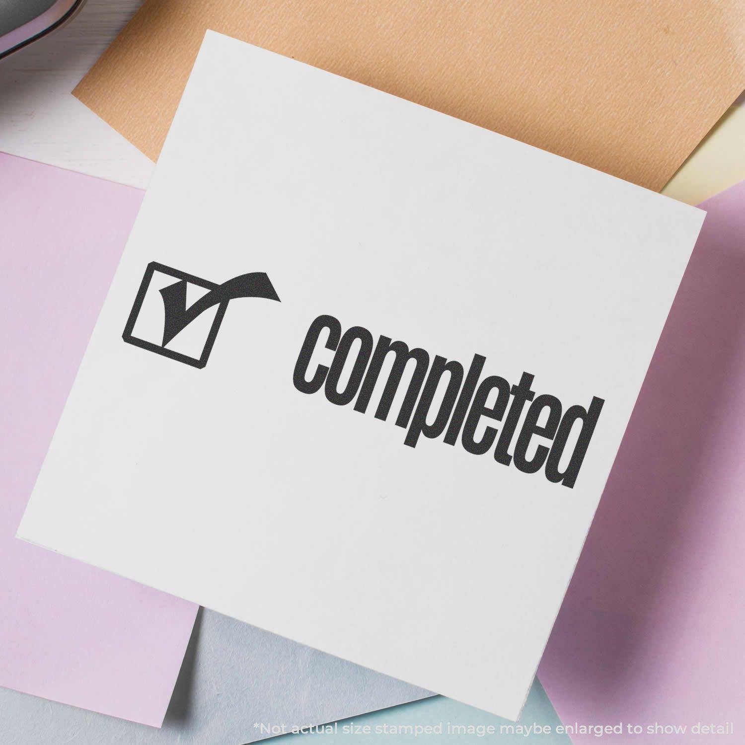 Completed with Checkbox Rubber Stamp on white paper, surrounded by pastel-colored sheets, showing a checkmark and the word 'completed'.