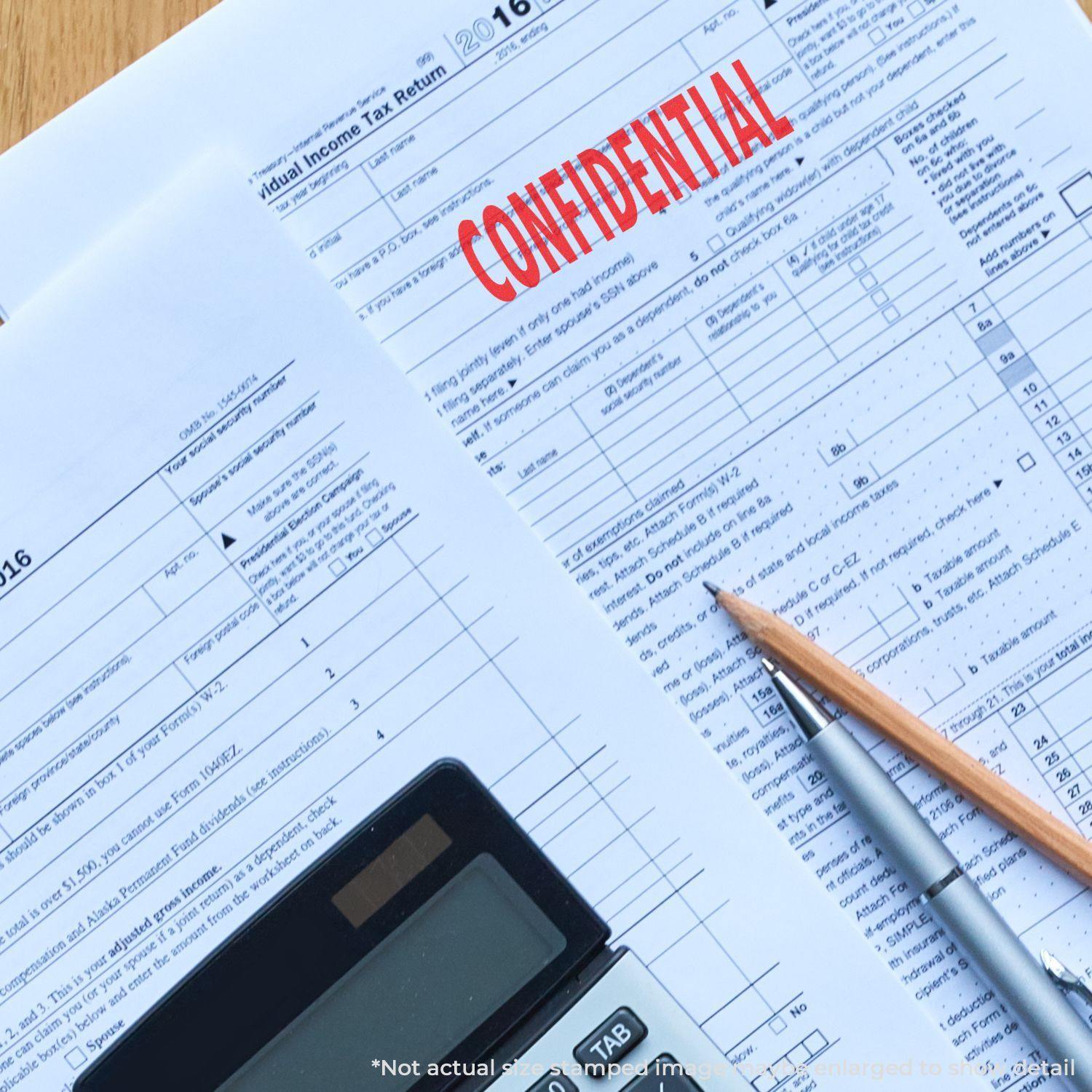 A document stamped with CONFIDENTIAL using a Self Inking Confidential Stamp, alongside a calculator, pen, and pencil on a desk.