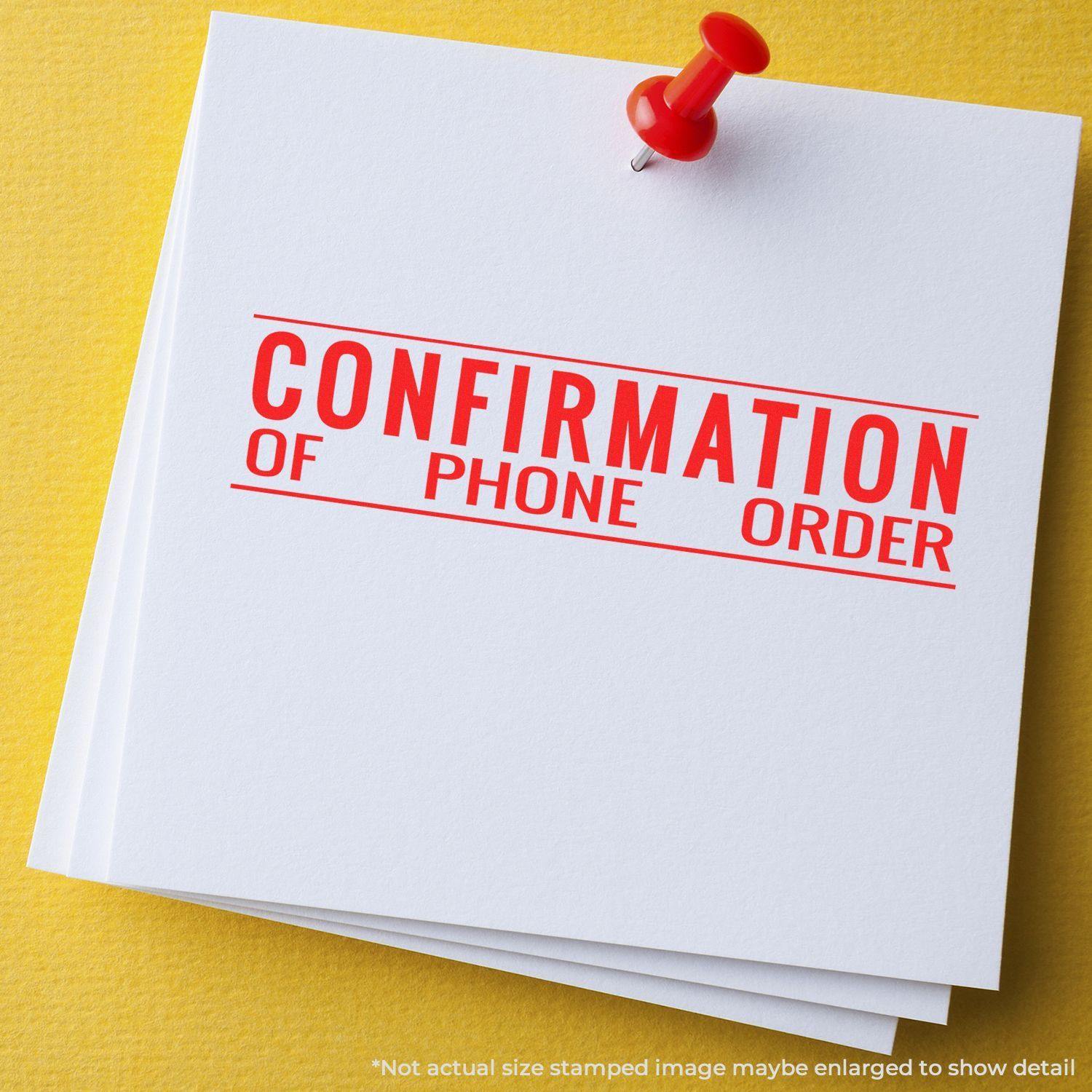 Large Confirmation of Phone Order Rubber Stamp used on white paper pinned with a red pushpin against a yellow background.