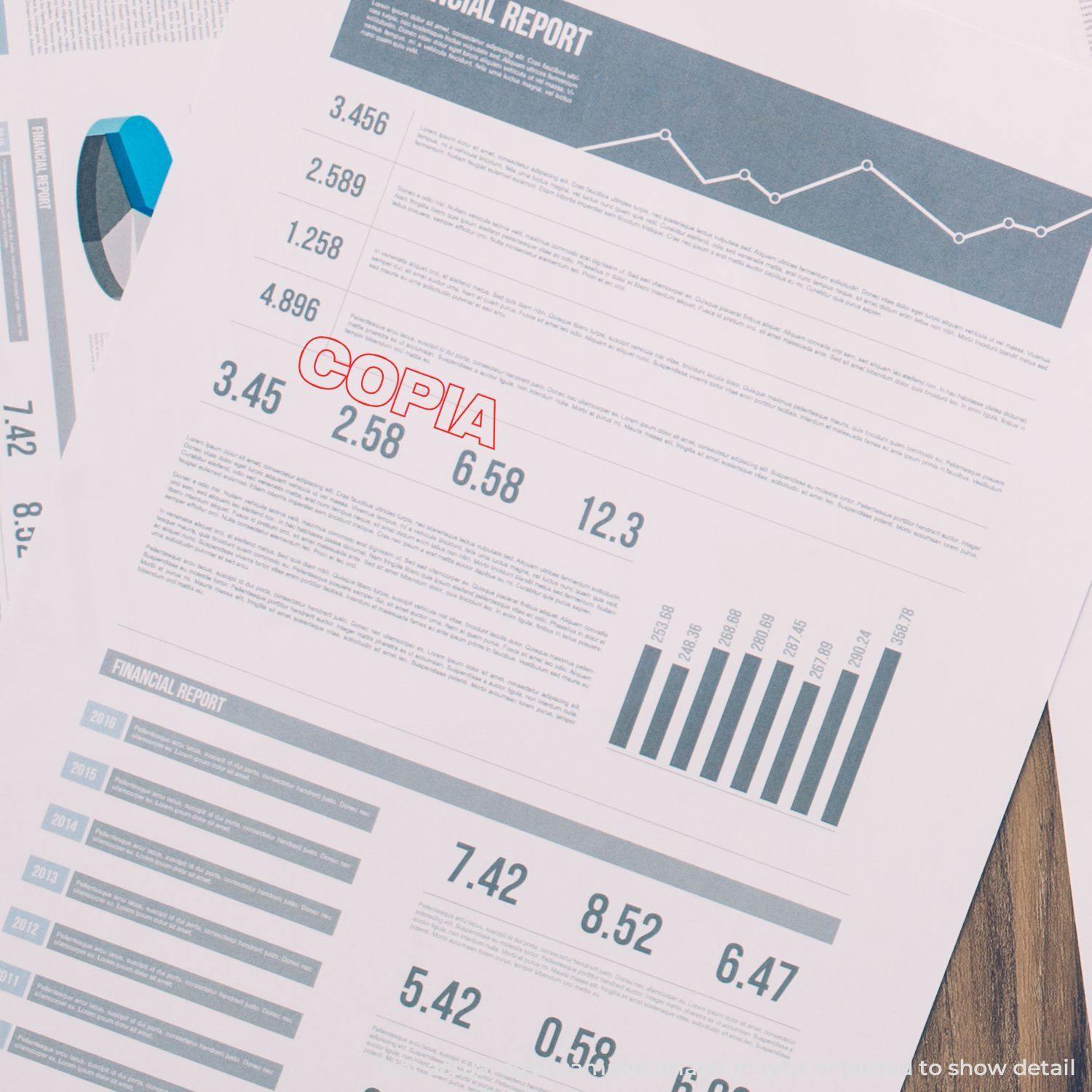 Financial reports stamped with Large Copia Rubber Stamp in red ink, highlighting important sections on a desk.