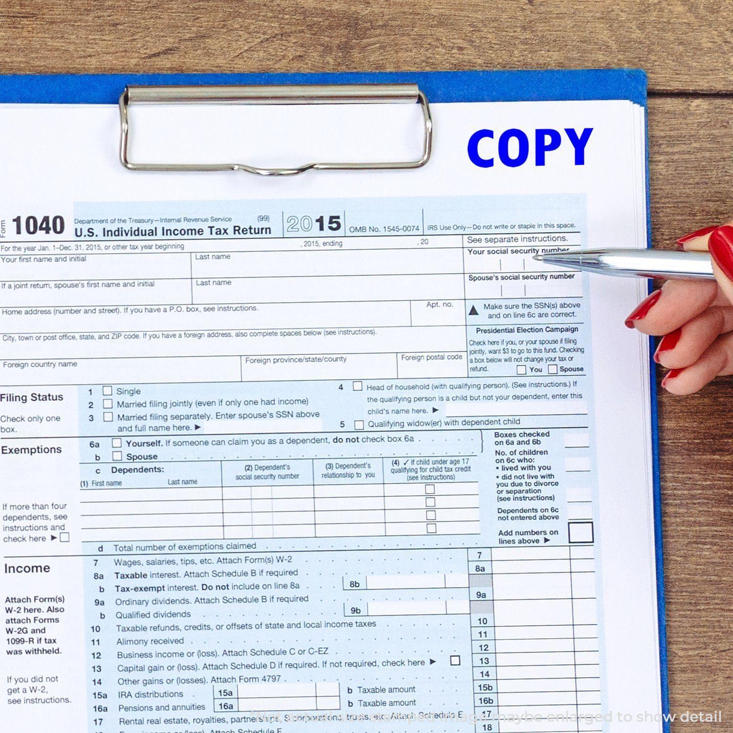 A hand holding a pen points to a U.S. Individual Income Tax Return form stamped with COPY using a Large Pre-Inked Copy Stamp.