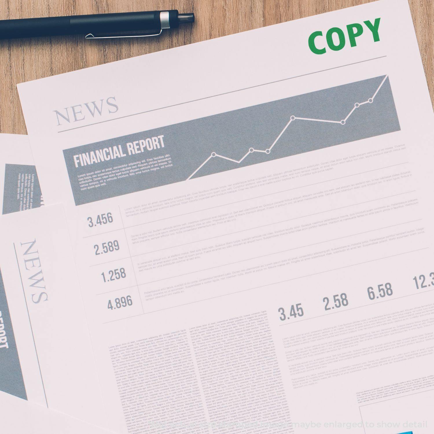 Large Pre-Inked Copy Stamp marking COPY in green on financial report papers, with a pen placed nearby.