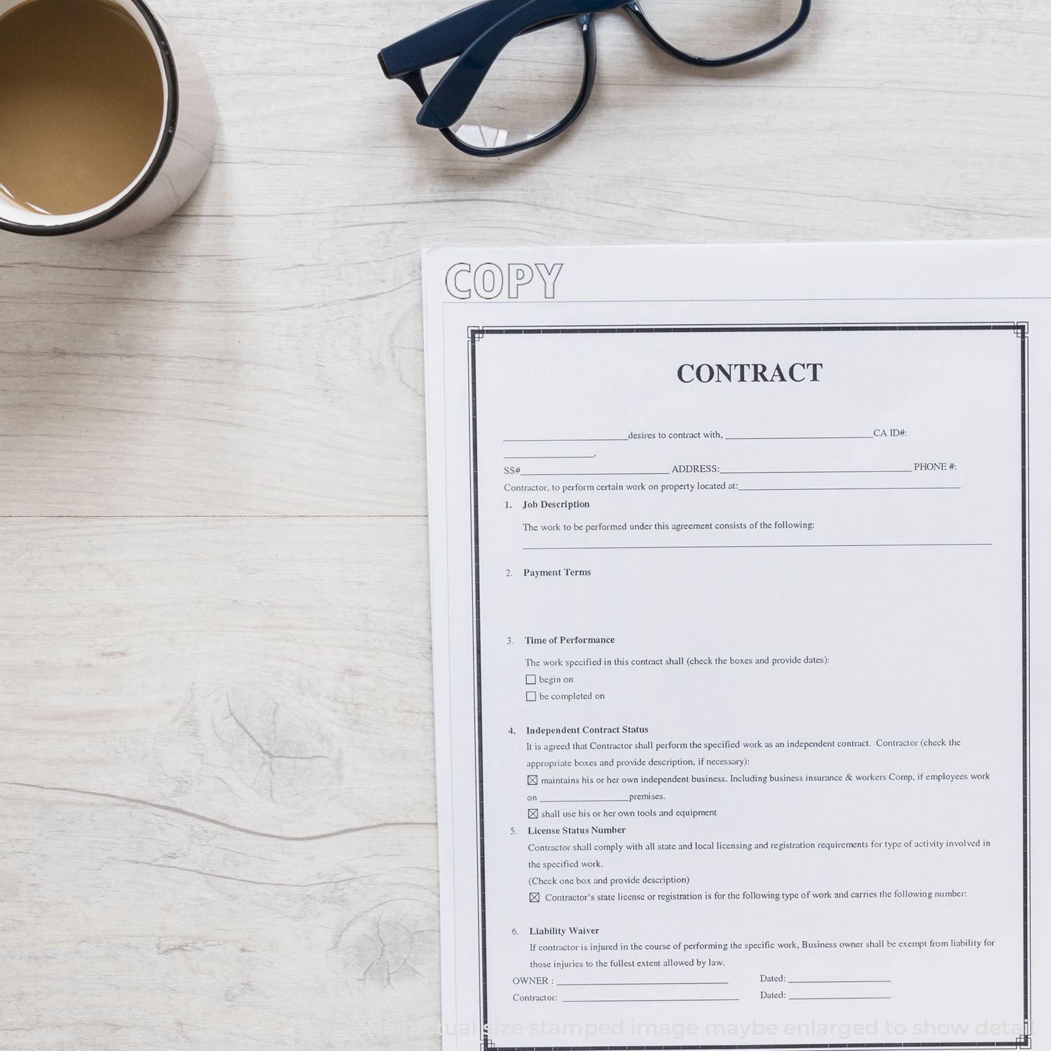 Copy Outline Text Rubber Stamp used on a contract document placed on a wooden desk with a cup of coffee and a pair of glasses nearby.