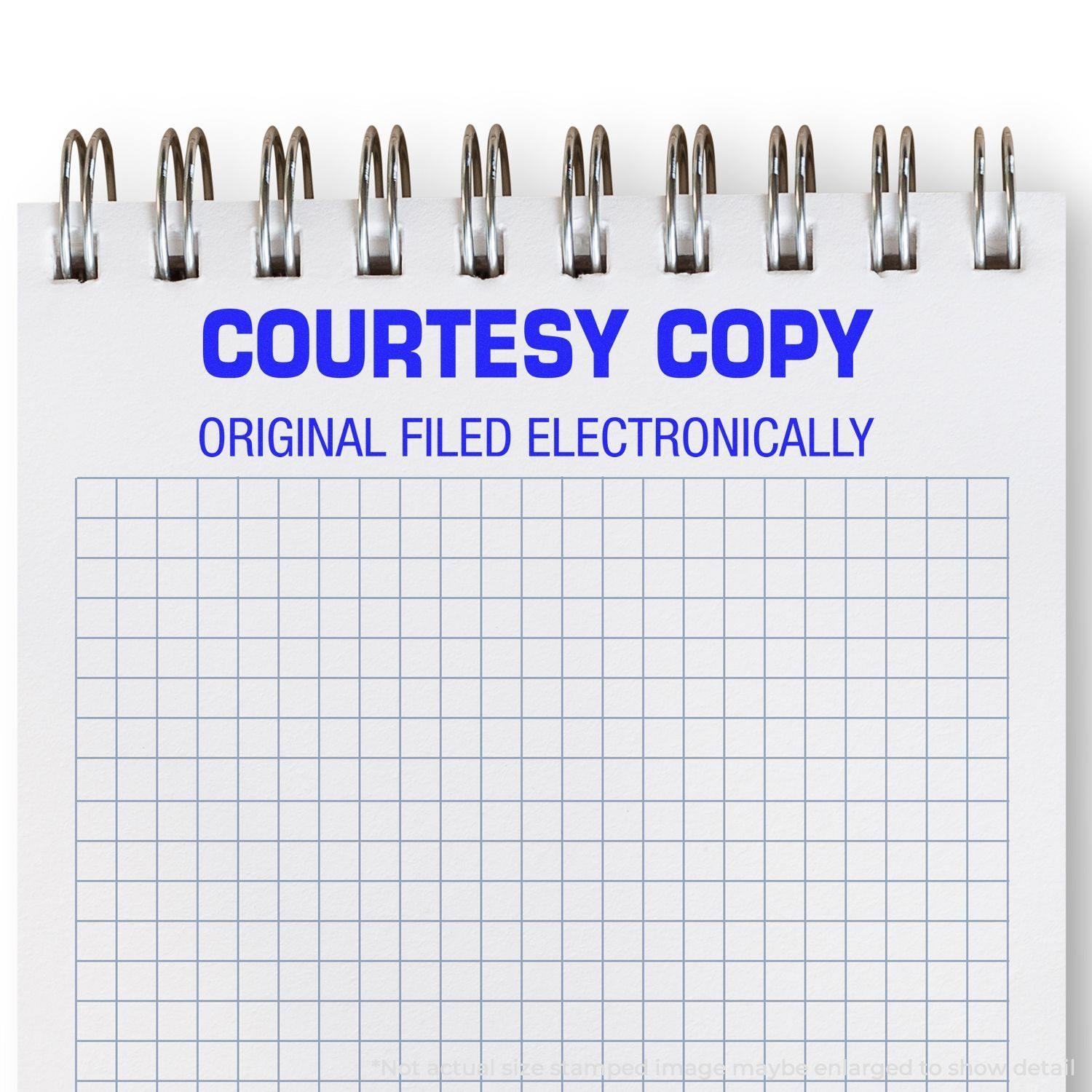 Large Self Inking Courtesy Copy Original Filed Electronically Stamp used on a spiral notebook with a grid pattern.