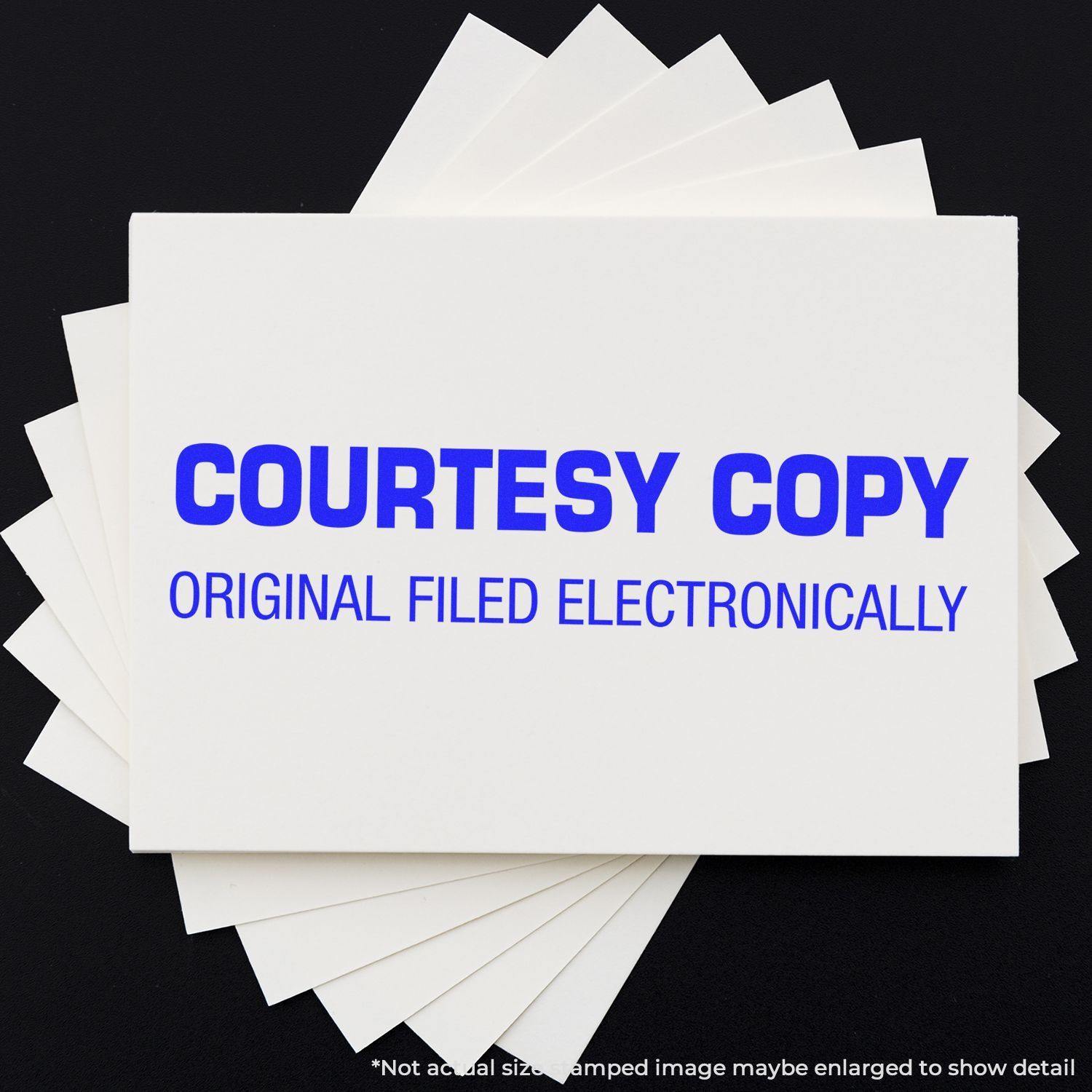 Courtesy Copy Original Filed Electronically Rubber Stamp in blue ink on a white card, with several white cards underneath on a black background.